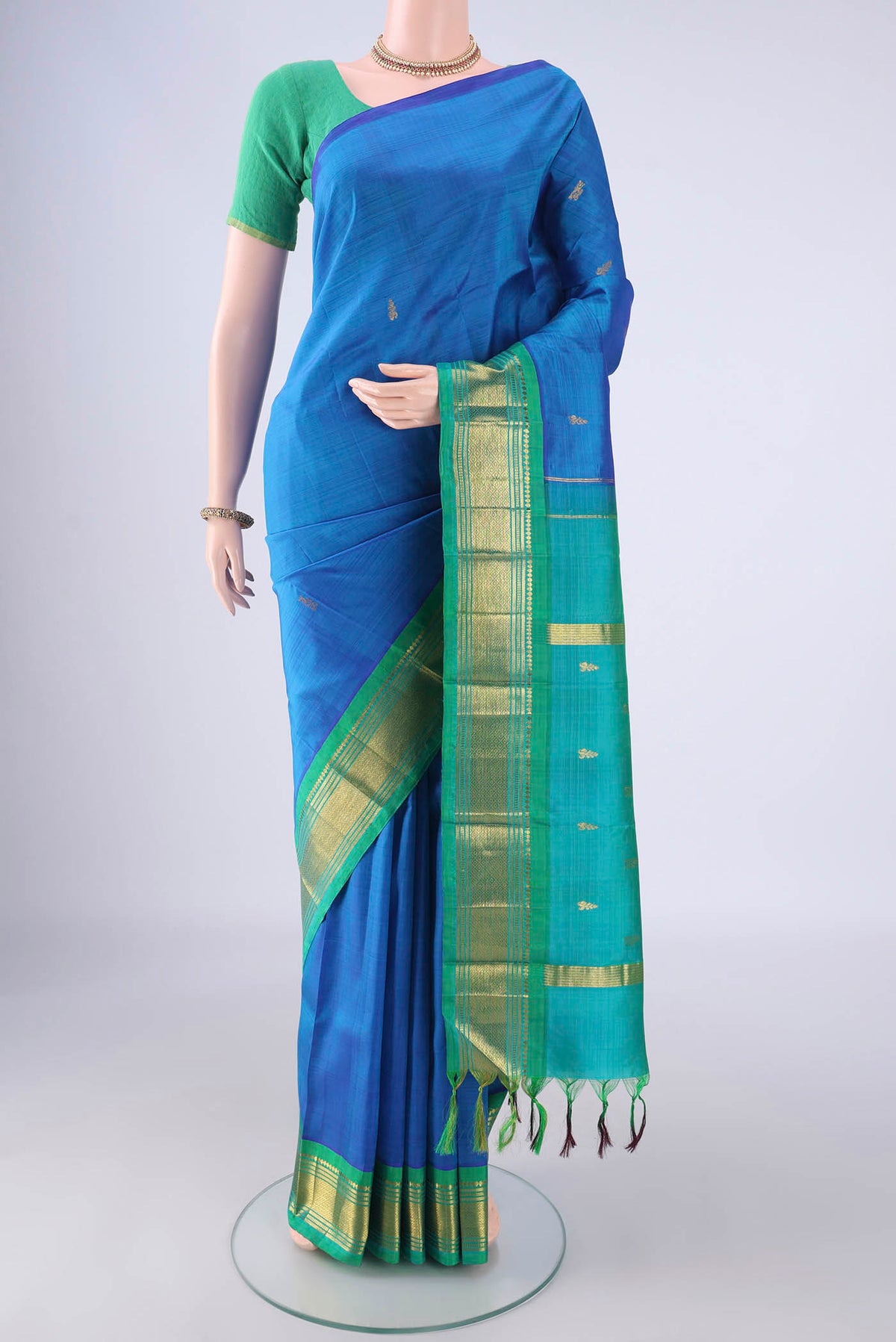 Blue Kanjivaram Silk Saree with Zari Butta on the body and One Side Border.  displayed on a mannequin