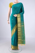 Teal Kanjivaram Silk Saree with Zari Butta on the body and One Side Border.  displayed on a mannequin