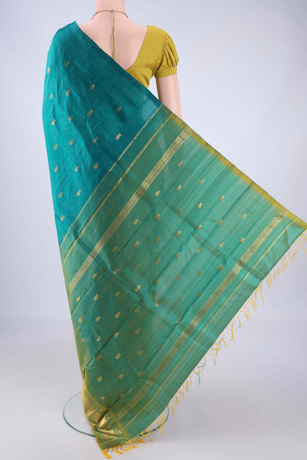 Flat view of Teal Kanjivaram Silk Saree with Zari Butta on the body and One Side Border. 