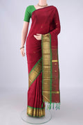 Maroon Kanjivaram Silk Saree with Zari Butta on the body and One Side Border.  displayed on a mannequin