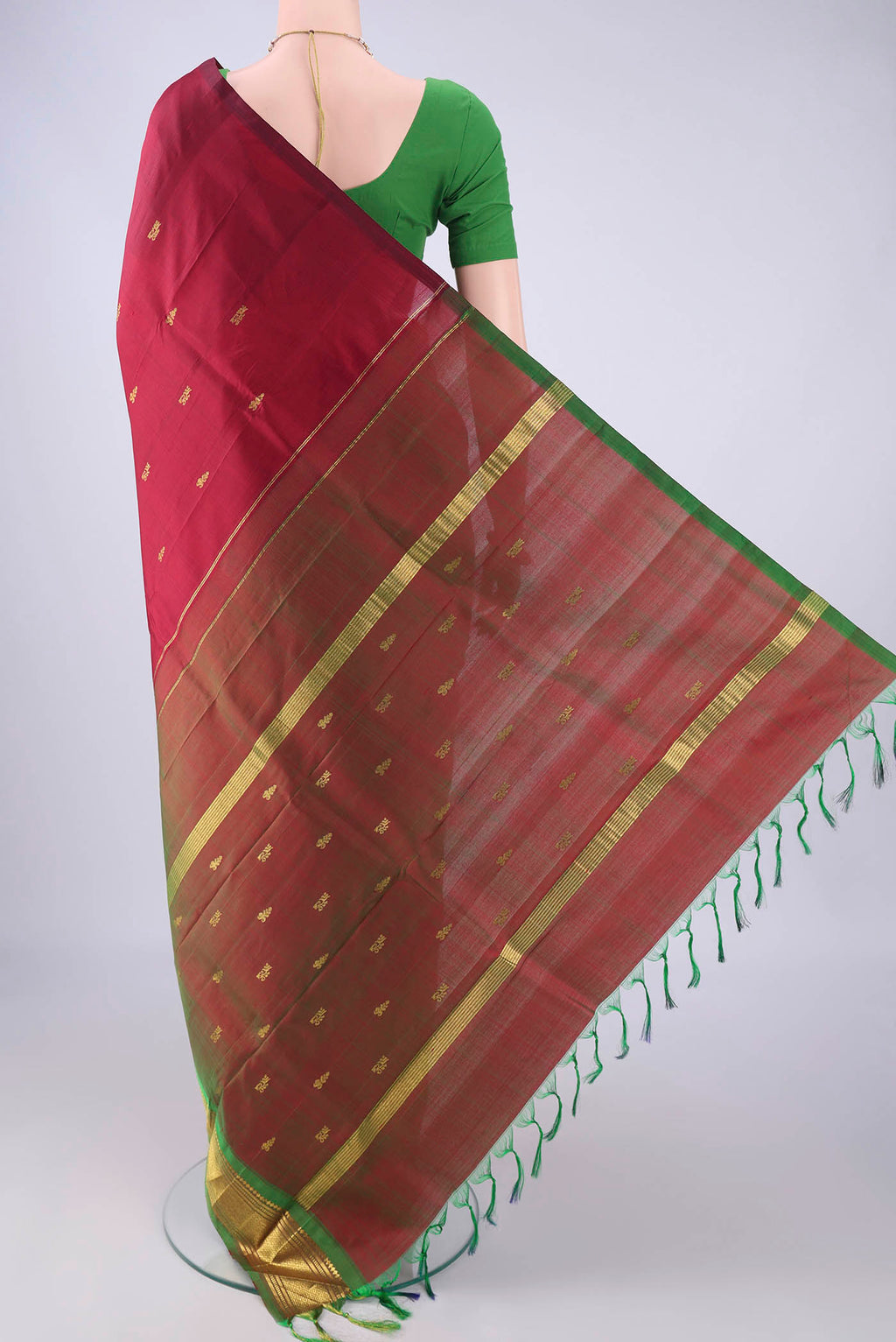 Flat view of Maroon Kanjivaram Silk Saree with Zari Butta on the body and One Side Border. 