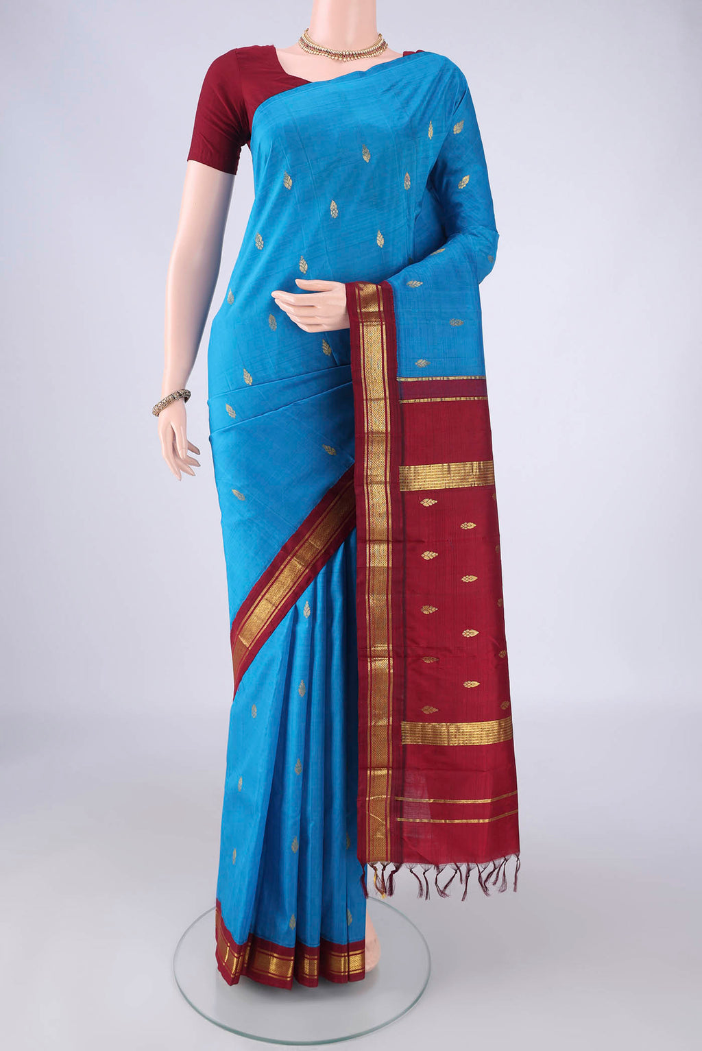 Blue Kanjivaram Silk Saree with Zari Butta on the body and One Side Border.  displayed on a mannequin