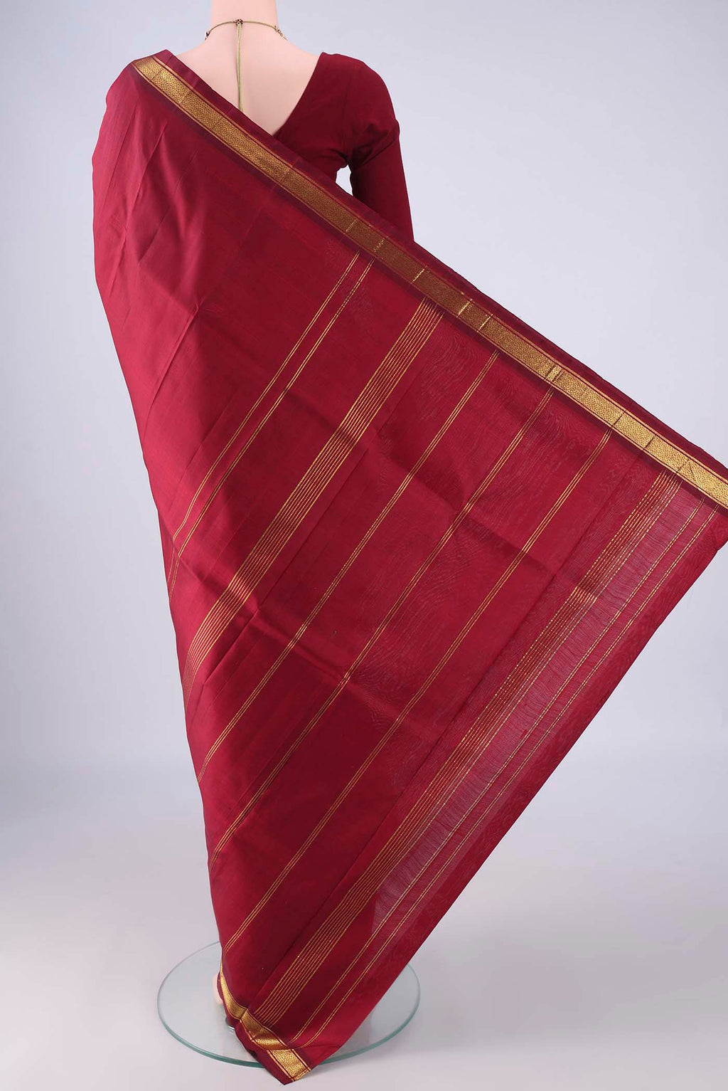 Flat view of Maroon Kanjivaram Silk Saree with Plain Body and Zari Border. 