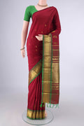 Pure Silk Maroon Kanjivaram Saree with Zari Butta on the body and One Side Border.  displayed on a mannequin
