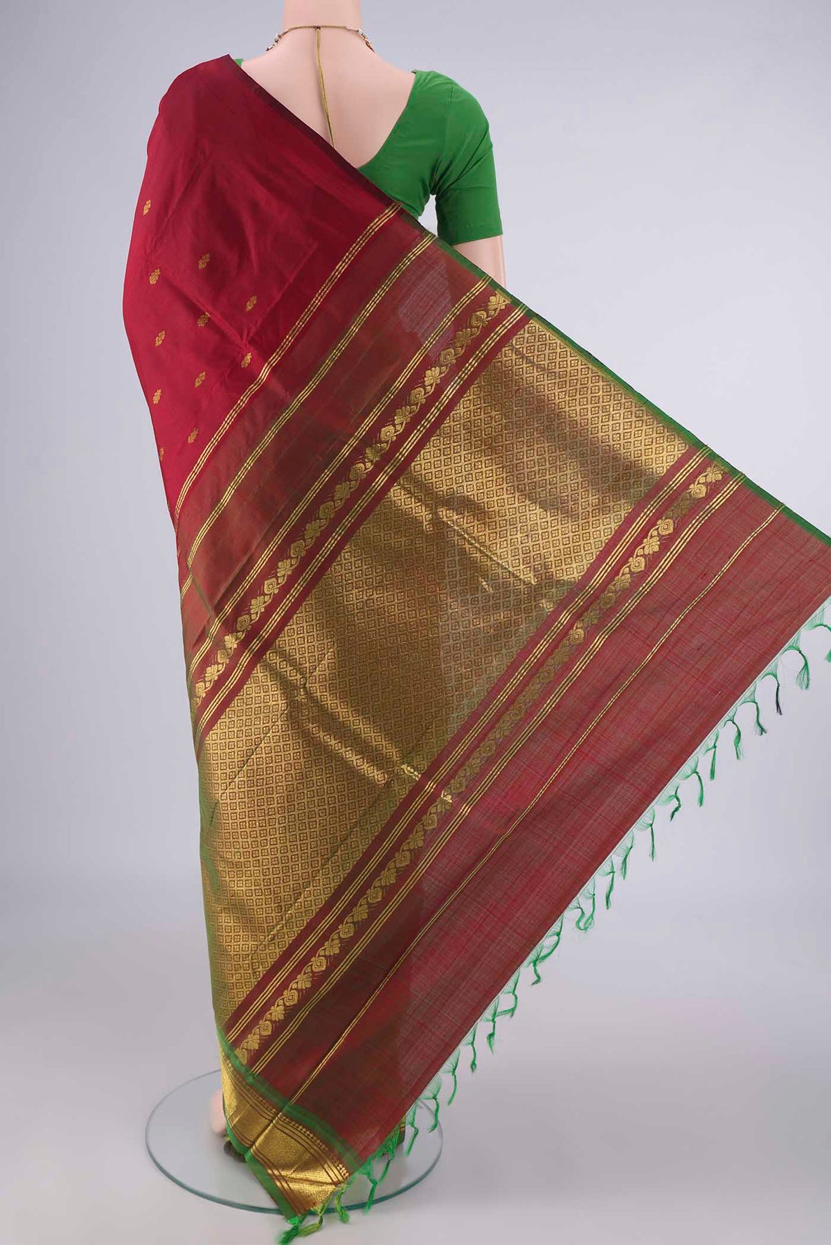 Flat view of Pure Silk Maroon Kanjivaram Saree with Zari Butta on the body and One Side Border. 