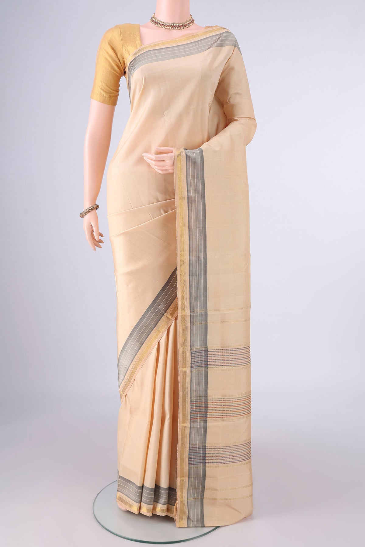 Pure Silk Sandal Kanjivaram Saree with Plain Body and Zari Border.  displayed on a mannequin