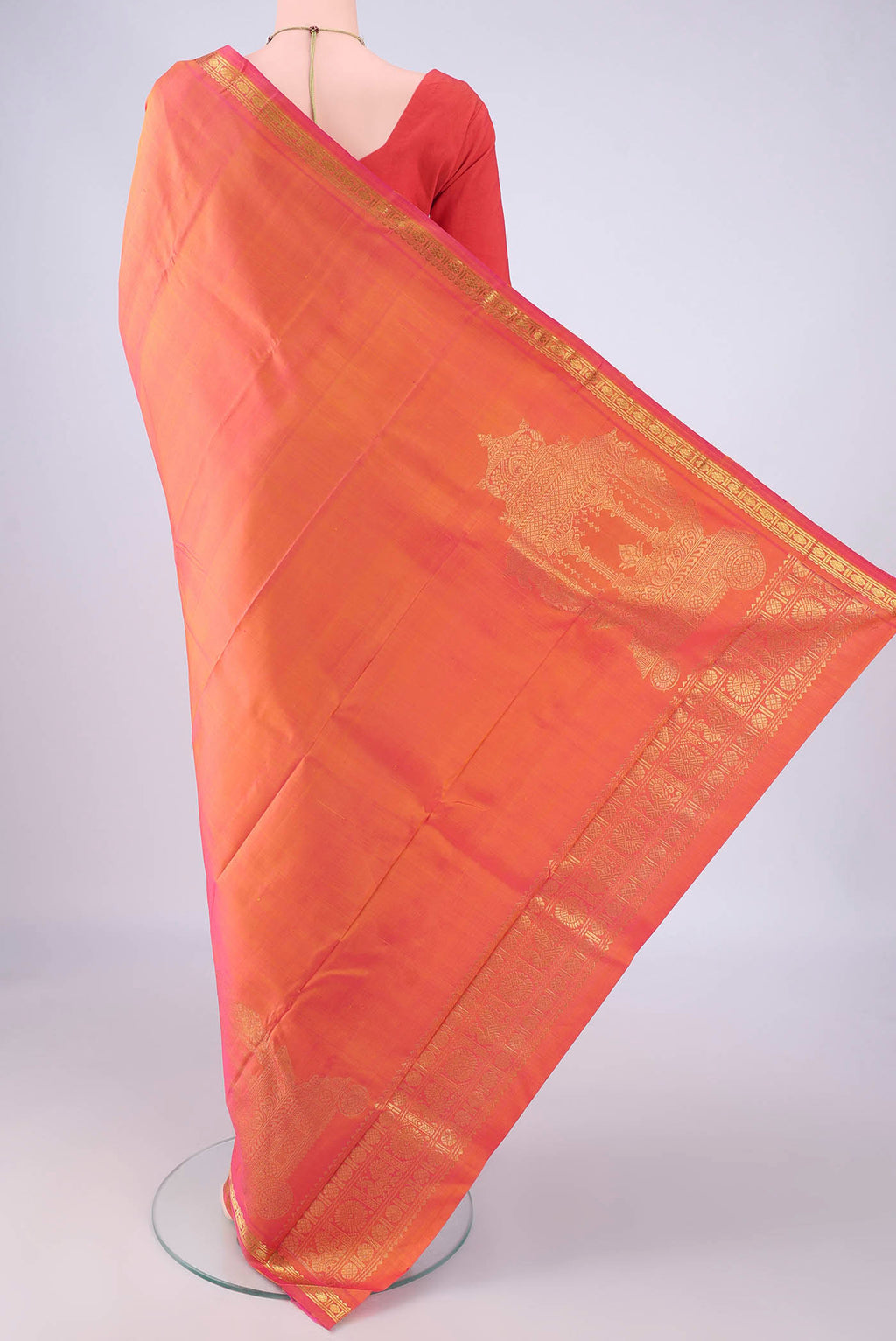 Flat view of Pure Silk Brick Orange Kanjivaram Silk Saree with Plain Body and Zari Border. 