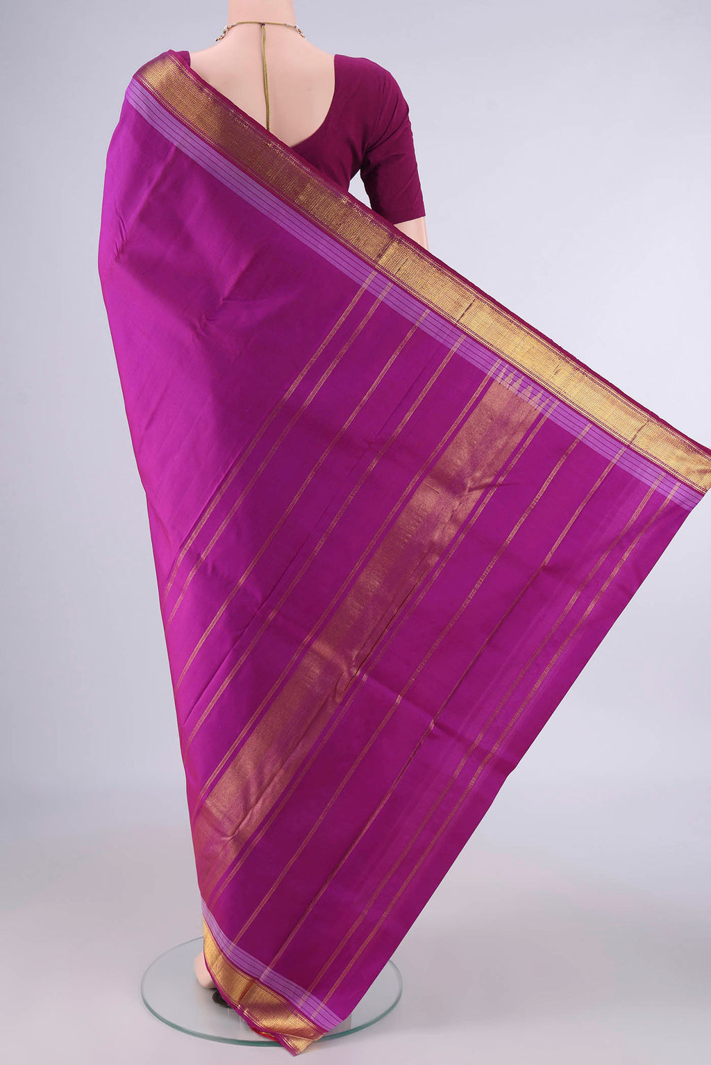 Flat view of Pure Silk Magenta Kanjivaram Saree with Plain Body and Zari Border. 