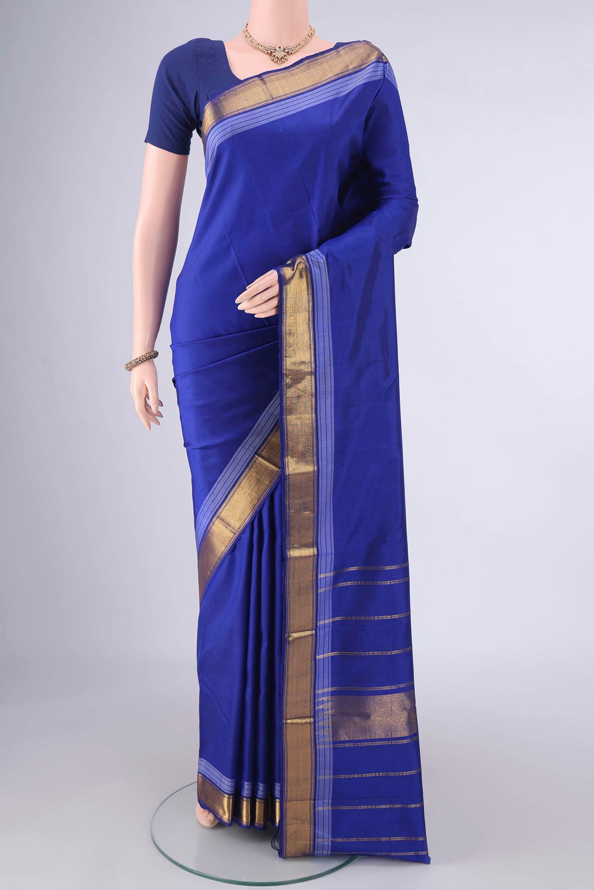 Royal Blue Kanjivaram Saree with Plain Body and Zari Border.  displayed on a mannequin