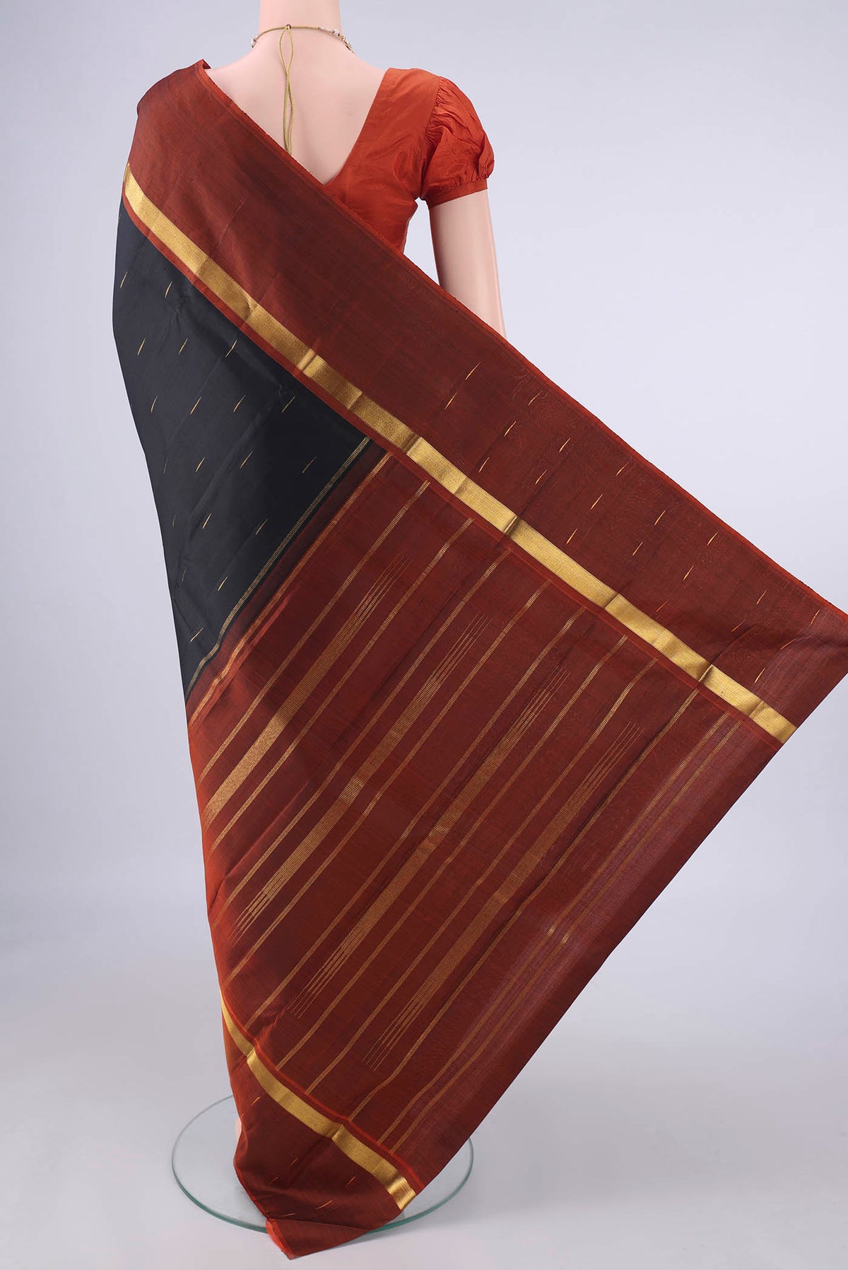 Flat view of Pure Silk Black Kanjivaram Saree with Zari Butta on the body and Zari Border. 