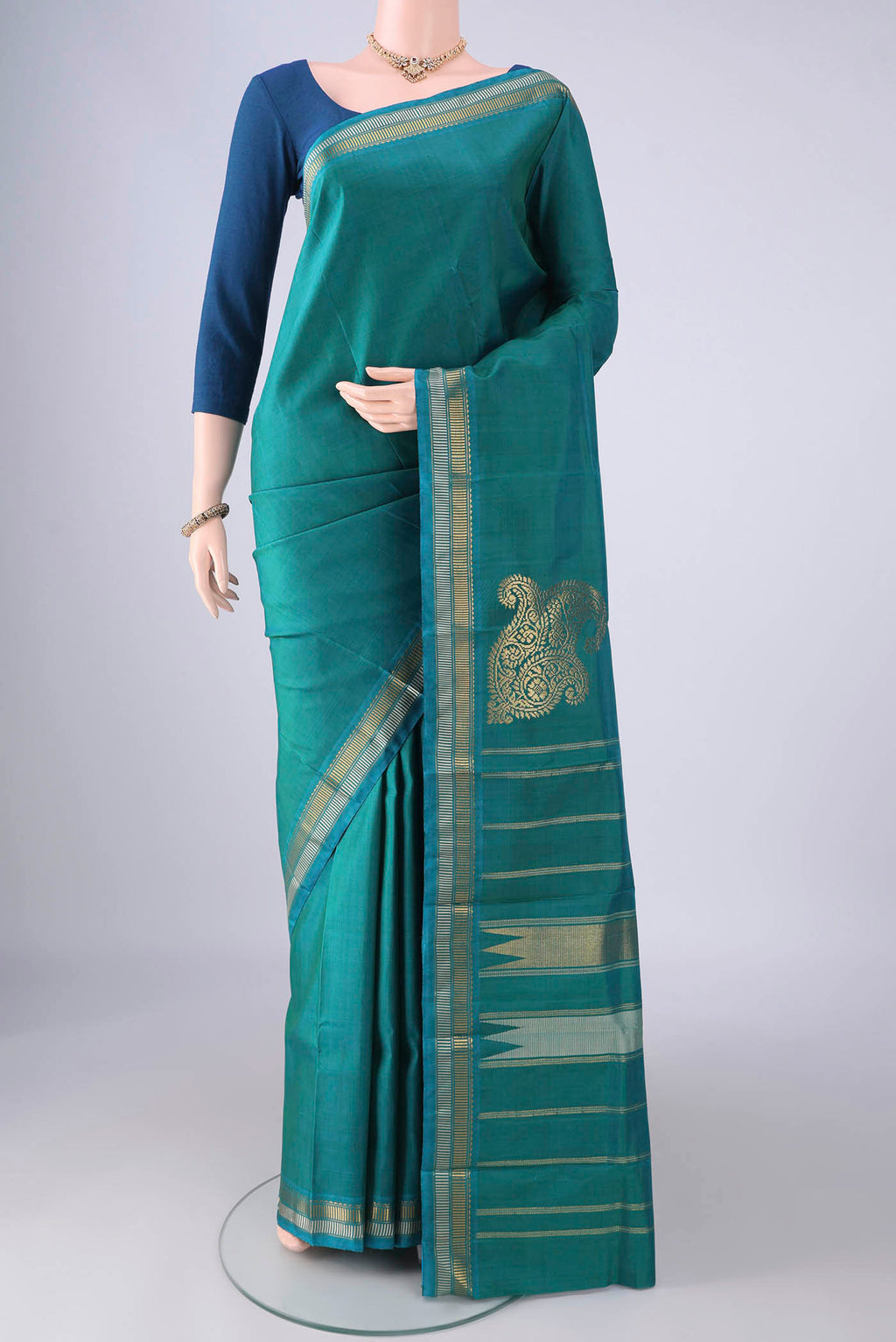 Sea Green Kanchipuram Silk Saree with Plain Body and Zari Border.  displayed on a mannequin