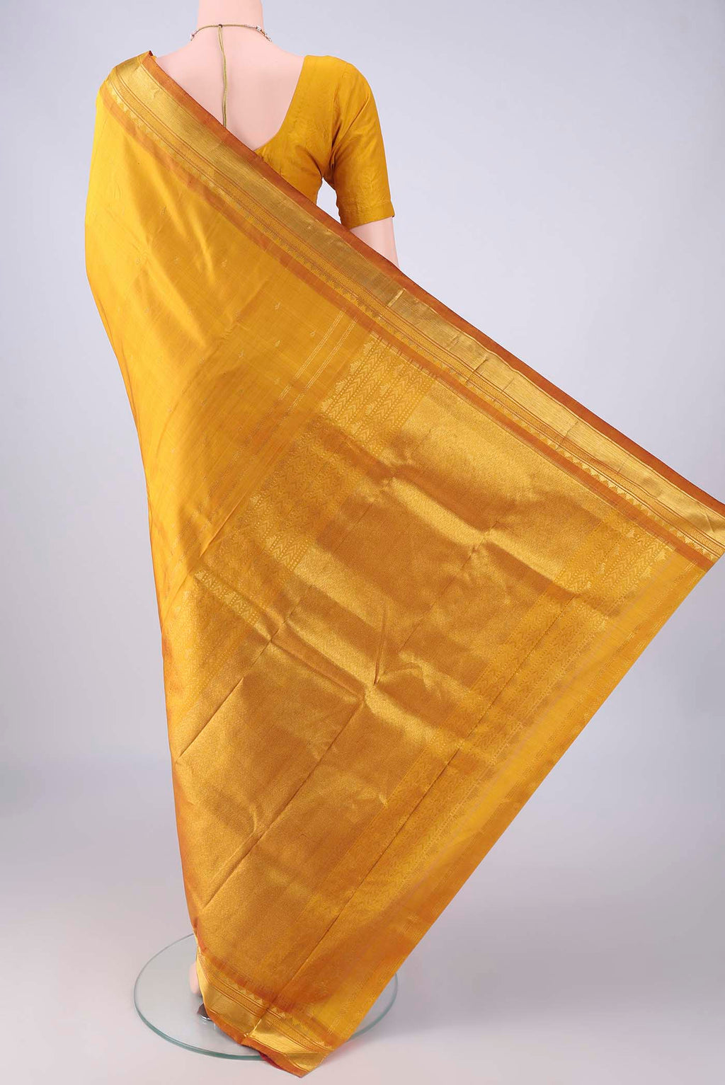 Flat view of Mustard Kanchipuram Silk Saree with Zari Butta on the body and Zari Border. 
