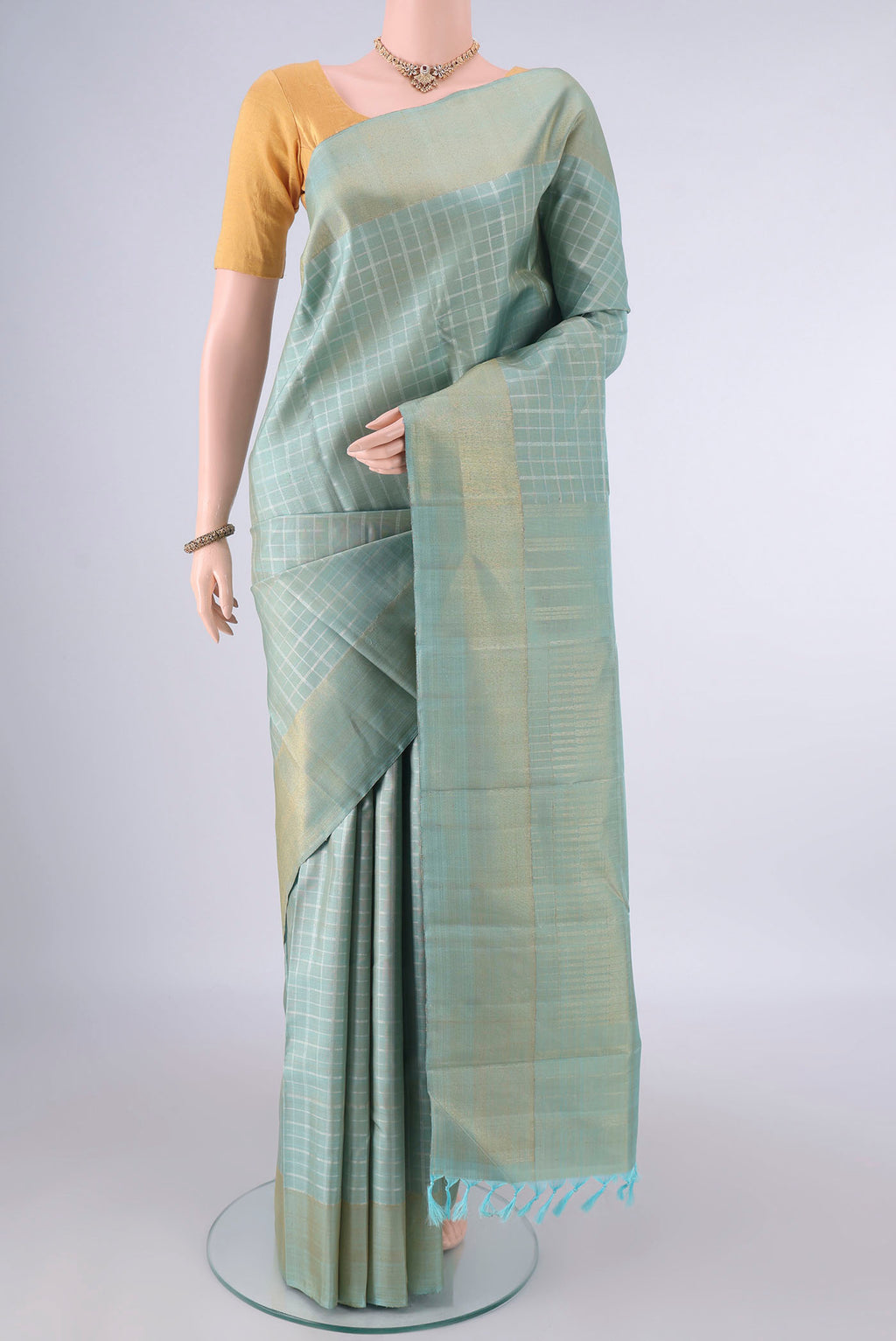 Pure Silk Pure Zari Sky Blue Kanjivaram Saree with Checked design on the body and Zari Border.  displayed on a mannequin