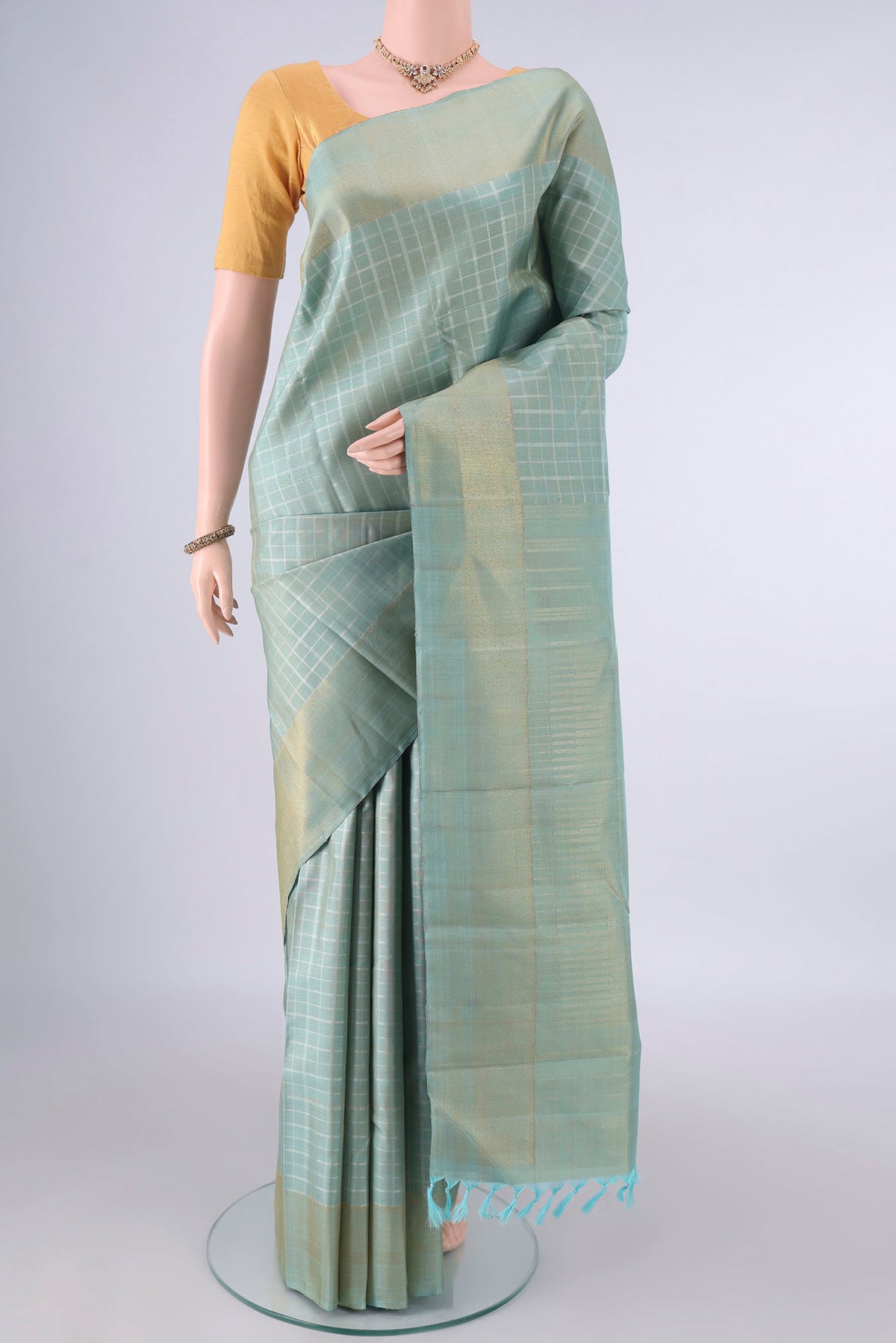 Pure Silk Pure Zari Sky Blue Kanjivaram Saree with Checked design on the body and Zari Border.  displayed on a mannequin
