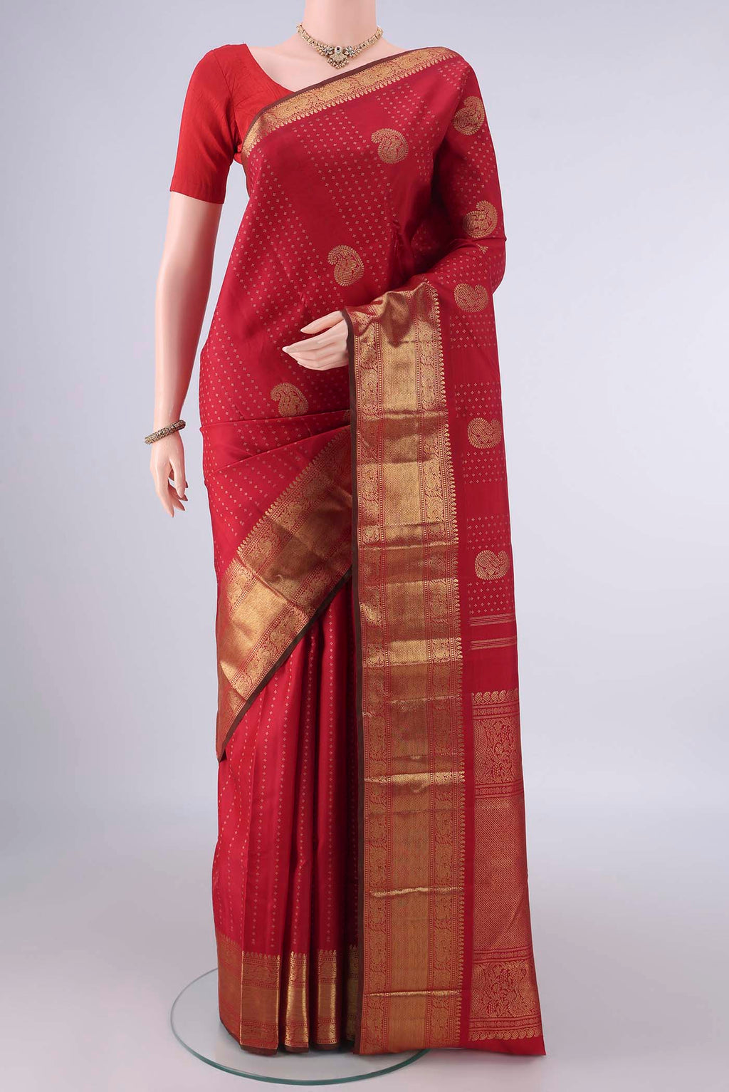 Pure Silk Pure Zari Red Kanjivaram Saree with Zari Butta on the body and Zari Border.  displayed on a mannequin