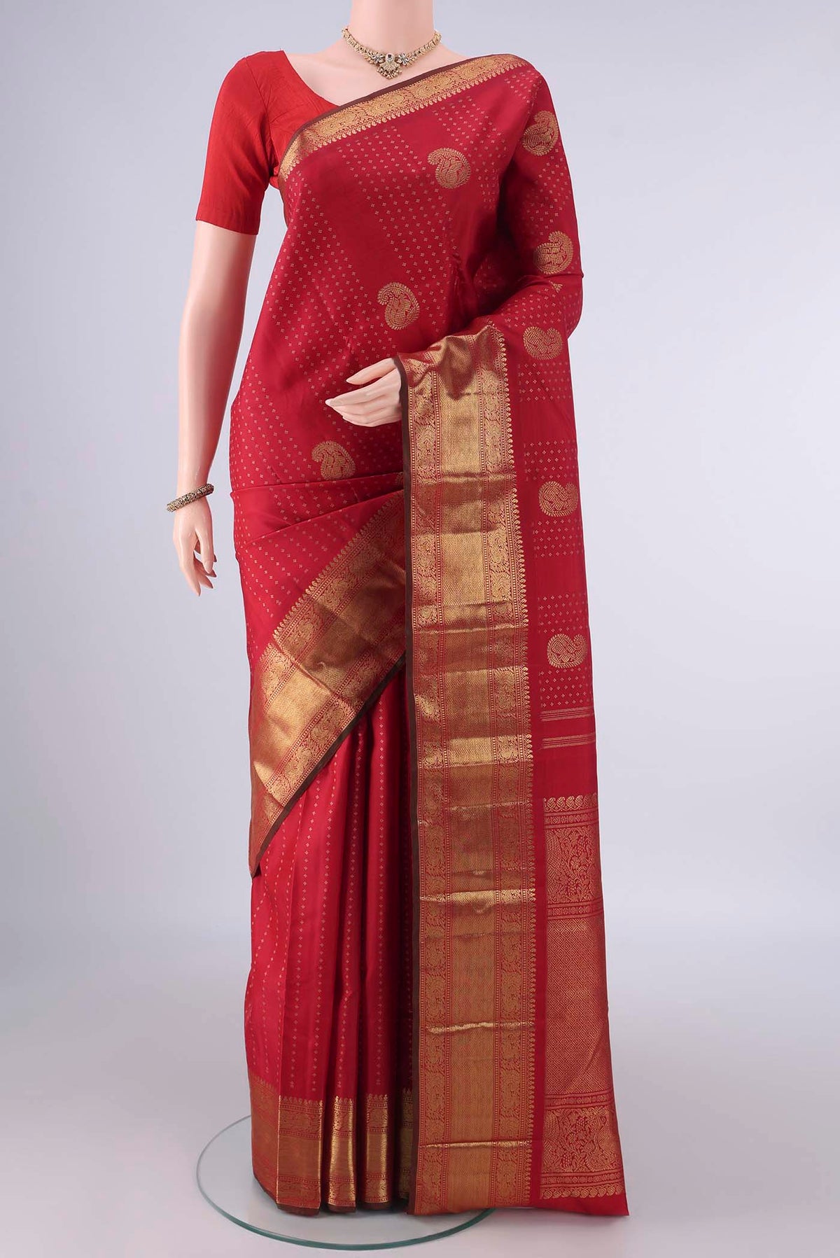 Pure Silk Pure Zari Red Kanjivaram Saree with Zari Butta on the body and Zari Border.  displayed on a mannequin