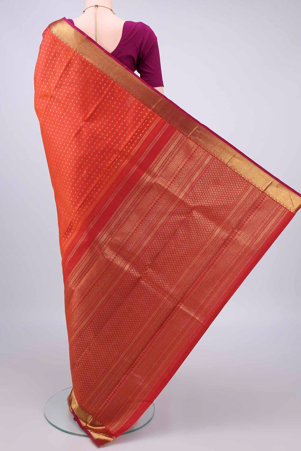 Flat view of Pure Silk Pure Zari Orange Kanjivaram Saree with Zari Butta on the body and Zari Border. 