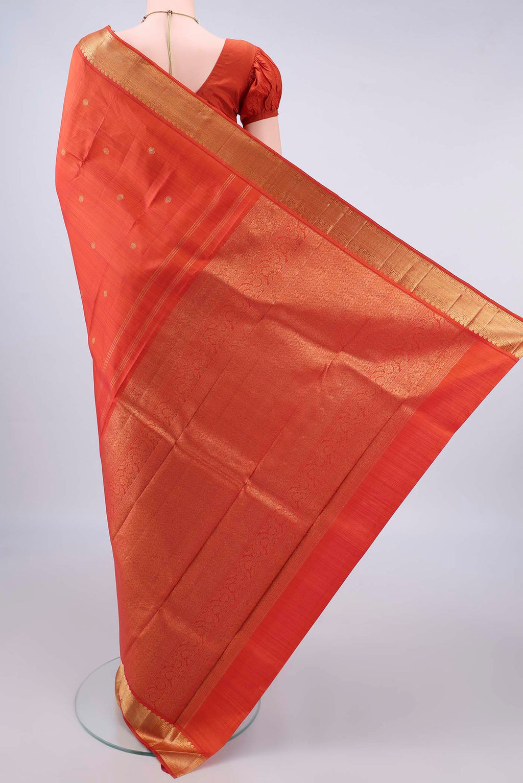 Flat view of Pure Silk Pure Zari Brick Orange Kanjivaram Saree with Zari Butta on the body and Zari Border. 