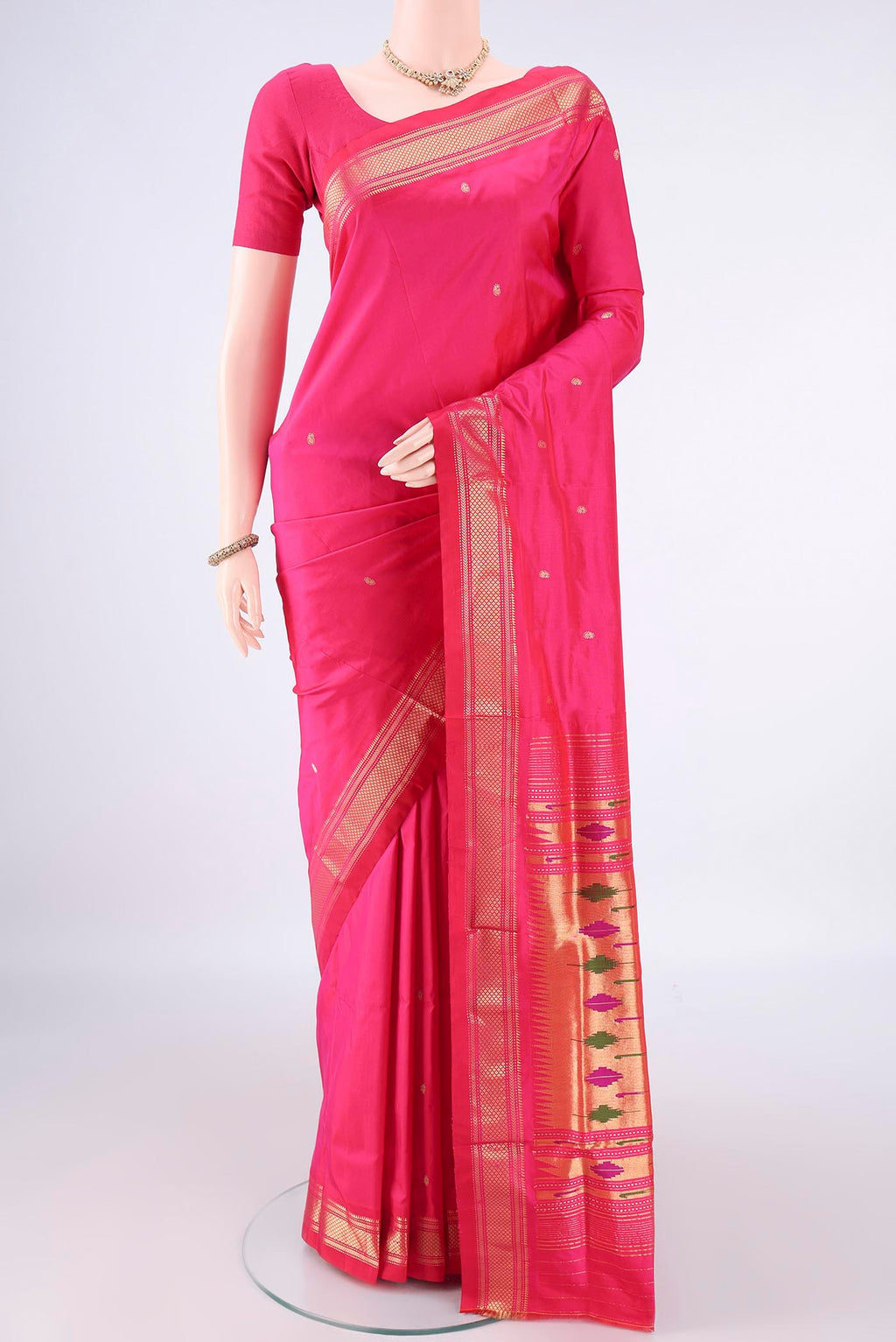 Pure Silk Rani Pink Paithani Saree with Plain Body and Zari Border.  displayed on a mannequin