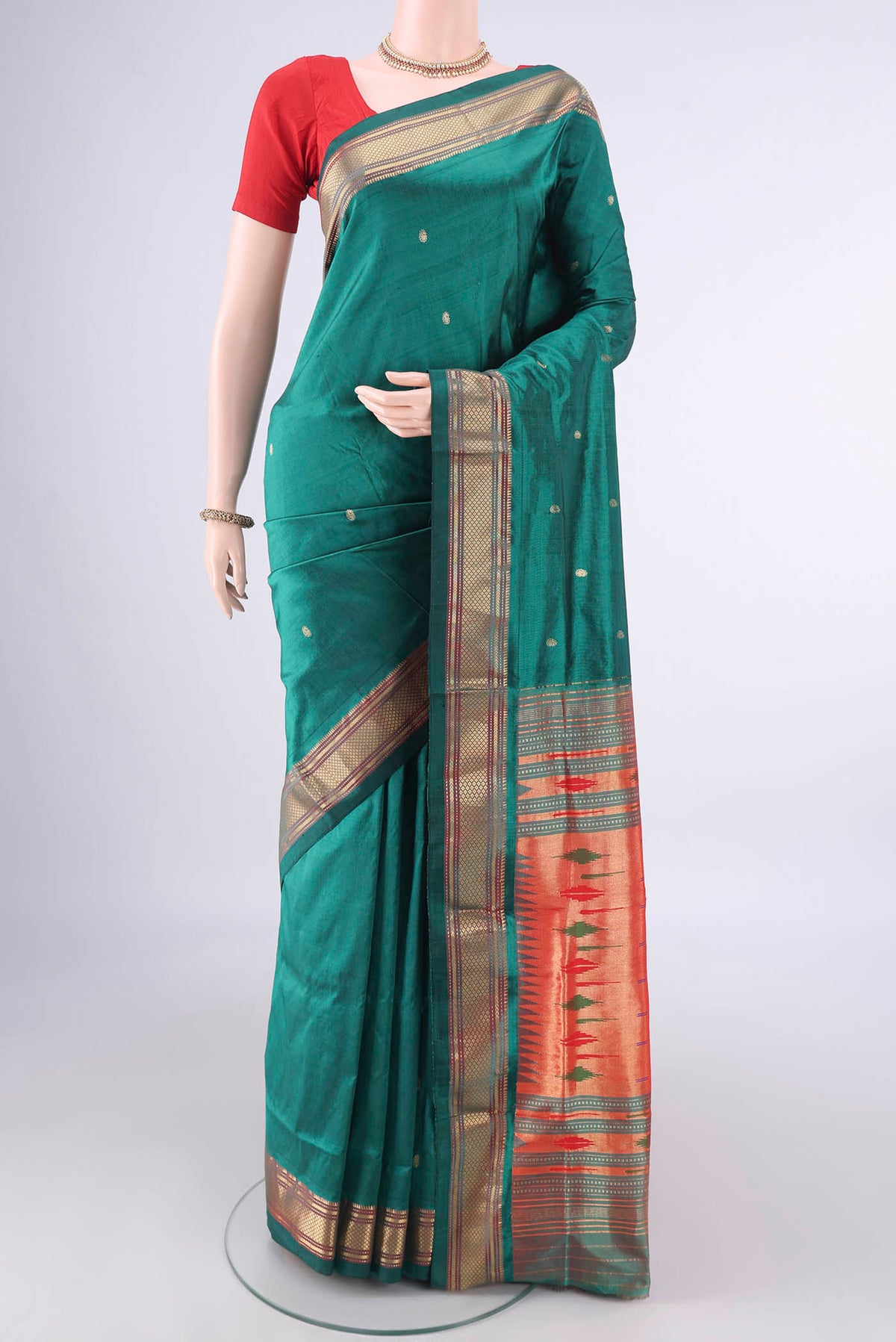 Pure Silk Bottle Green Paithani Saree with Plain Body and Zari Border.  displayed on a mannequin