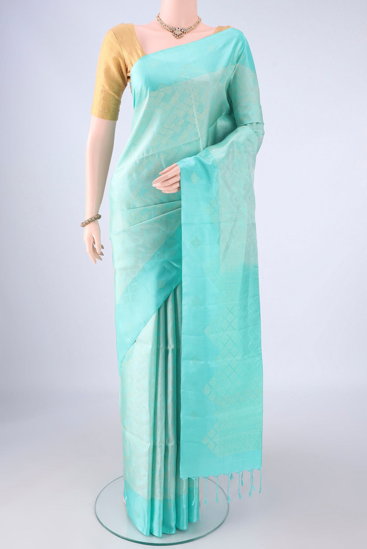 Pure Silk Turquoise Soft Silk Saree with Zari Brocade on the body and Zari Border.  displayed on a mannequin