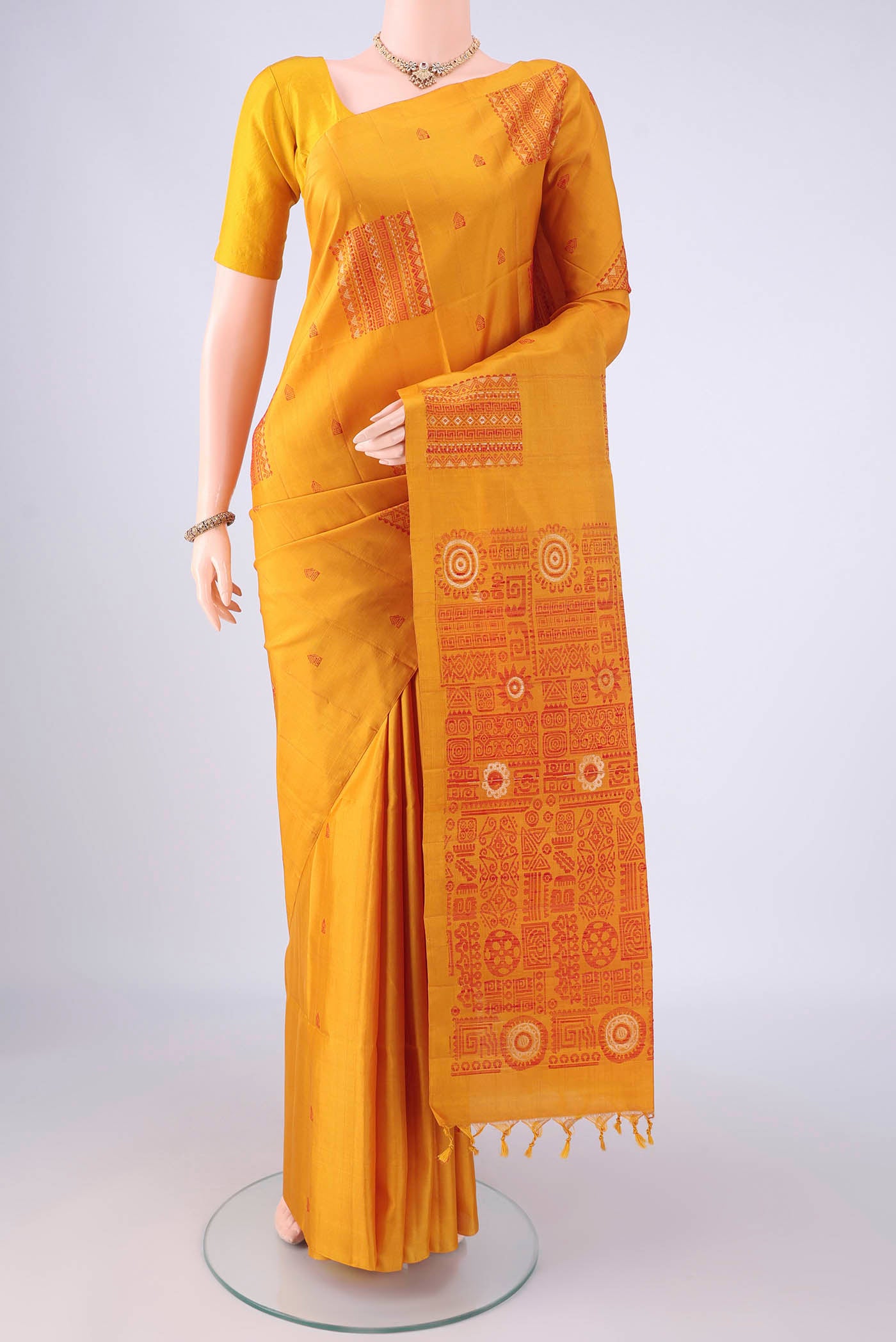 Pure Silk Mustard Soft Silk Saree with Thread Butta on the body and Plain Border.  displayed on a mannequin