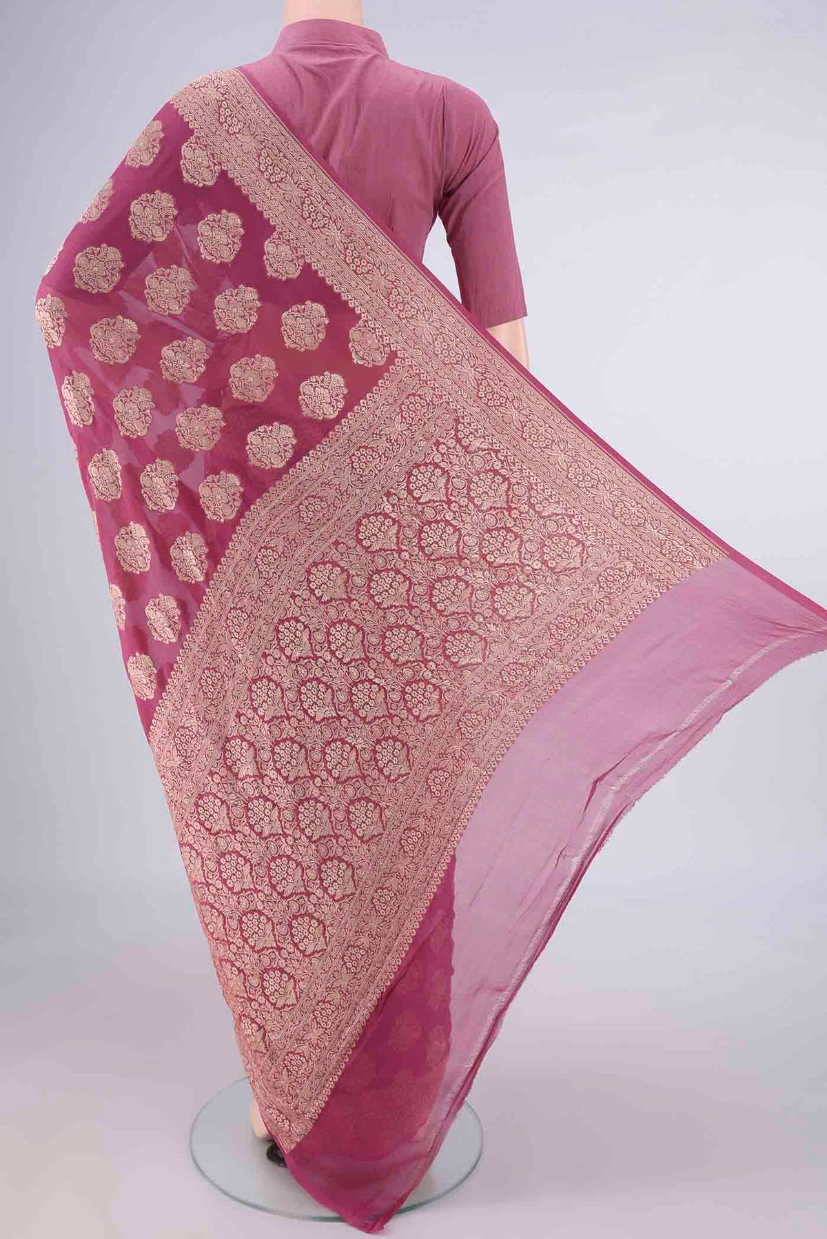 Flat view of Mauve Banarasi Georgette Saree with Zari Butta on the body and Zari Border. 