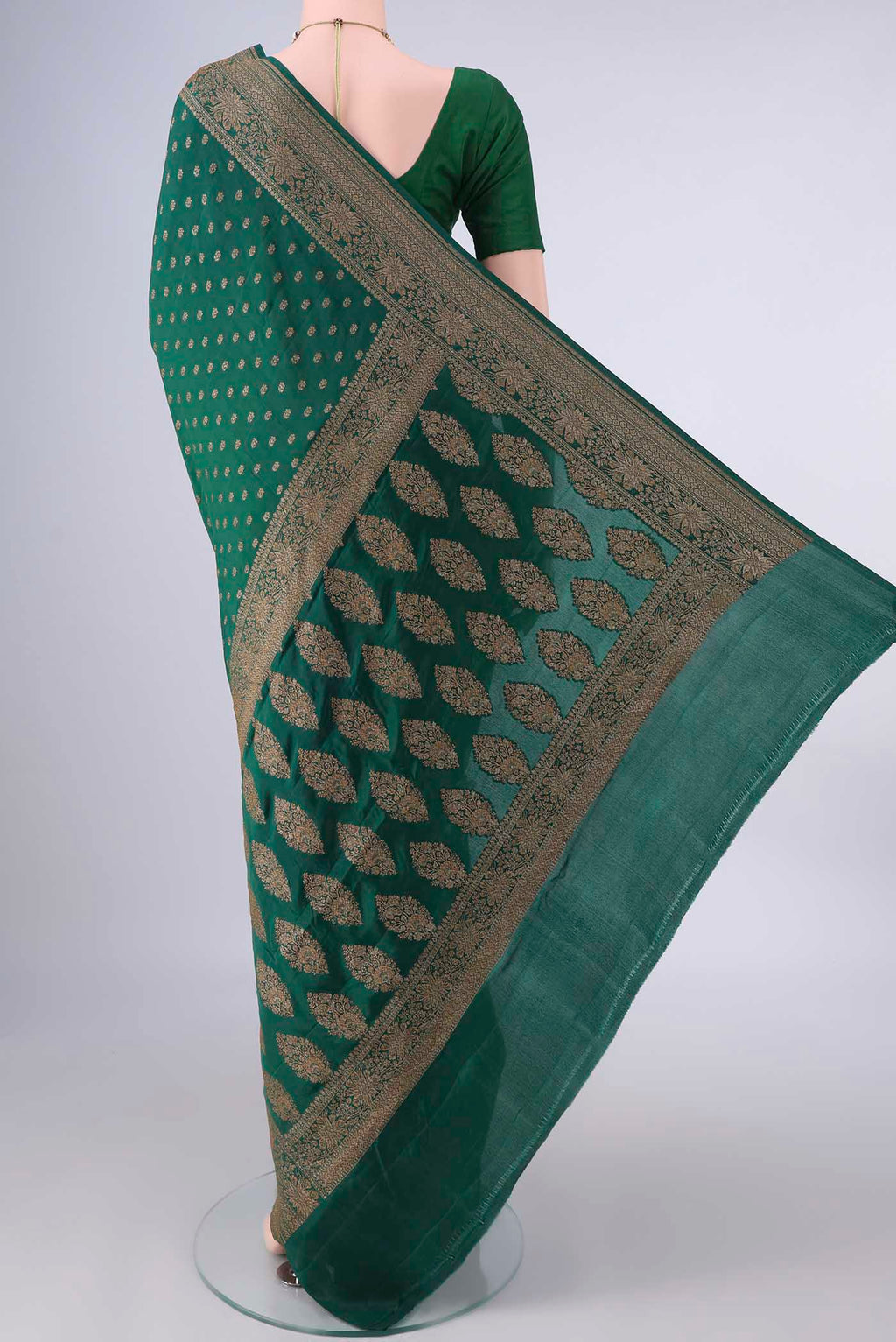 Flat view of Bottle Green Banarasi Georgette Saree with Zari Butta on the body and Zari Border. 