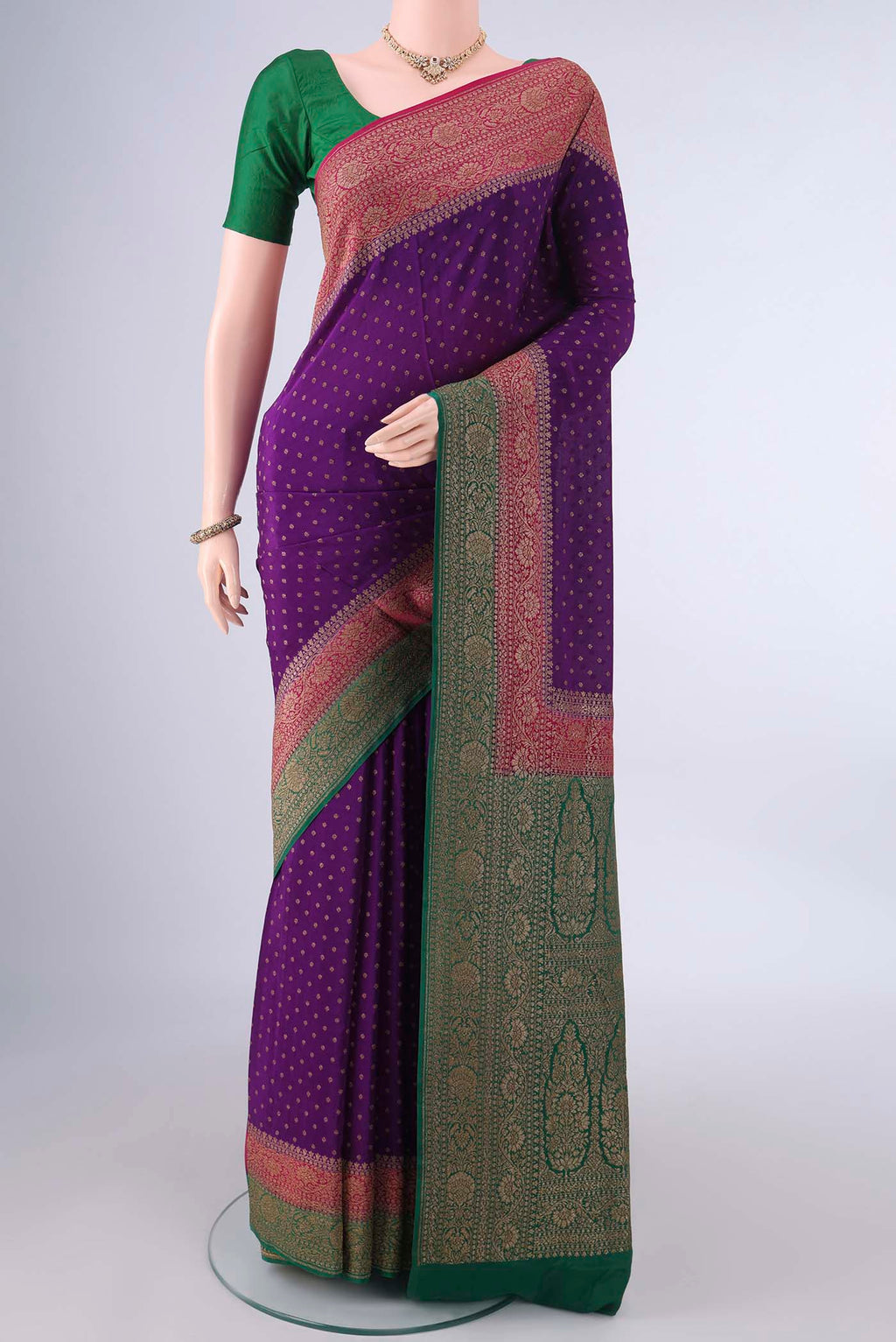 Violet Banarasi Georgette Saree with Zari Butta on the body and Ganga Jamuna Border.  displayed on a mannequin