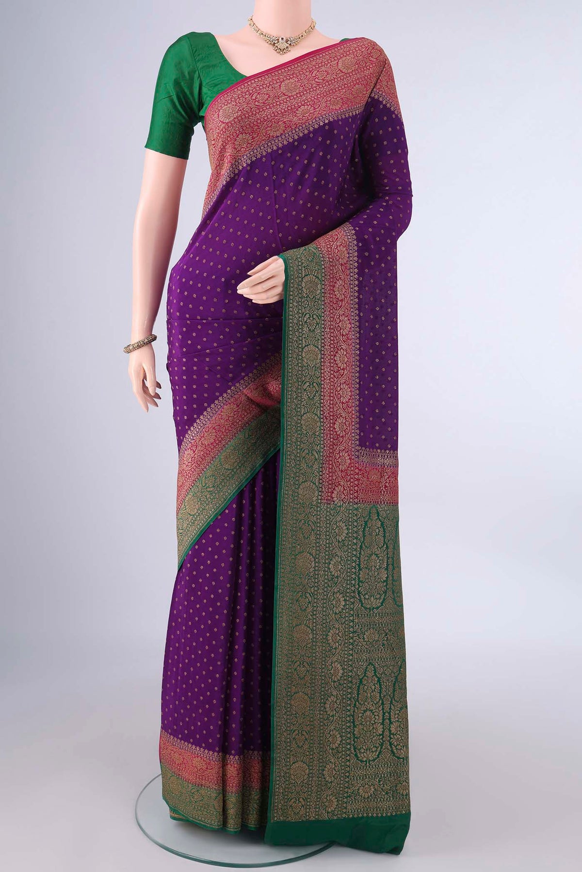 Violet Banarasi Georgette Saree with Zari Butta on the body and Ganga Jamuna Border.  displayed on a mannequin