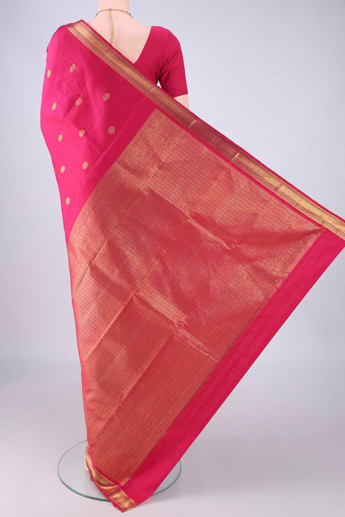 Flat view of Rani Pink Kanjivaram Silk Saree with Zari Butta on the body and Zari Border. 