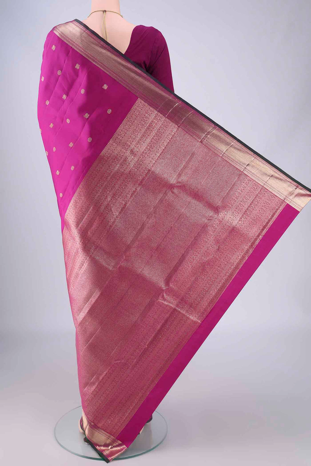 Flat view of Magenta Kanjivaram Silk Saree with Zari Butta on the body and Zari Border. 