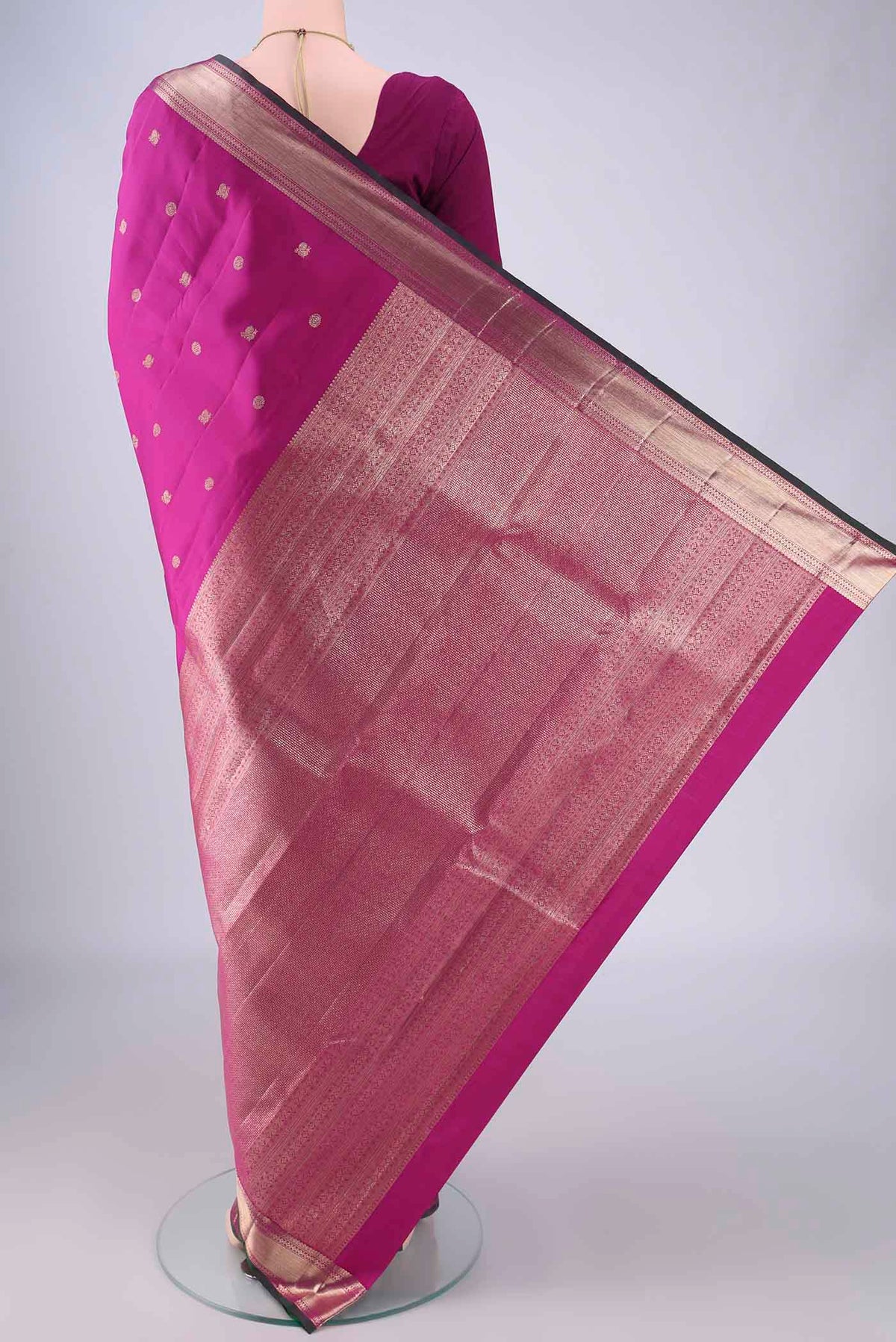 Flat view of Magenta Kanjivaram Silk Saree with Zari Butta on the body and Zari Border. 