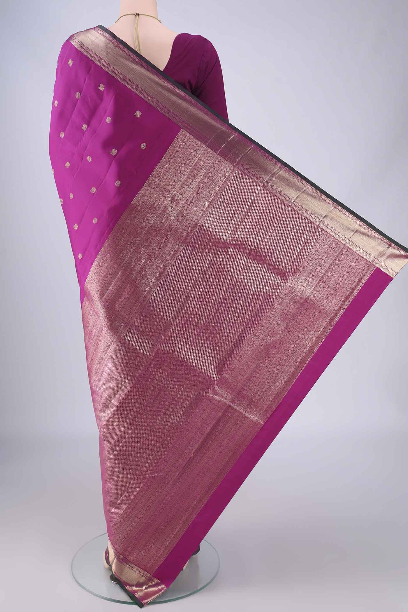 Flat view of Magenta Kanjivaram Silk Saree with Zari Butta on the body and Zari Border. 