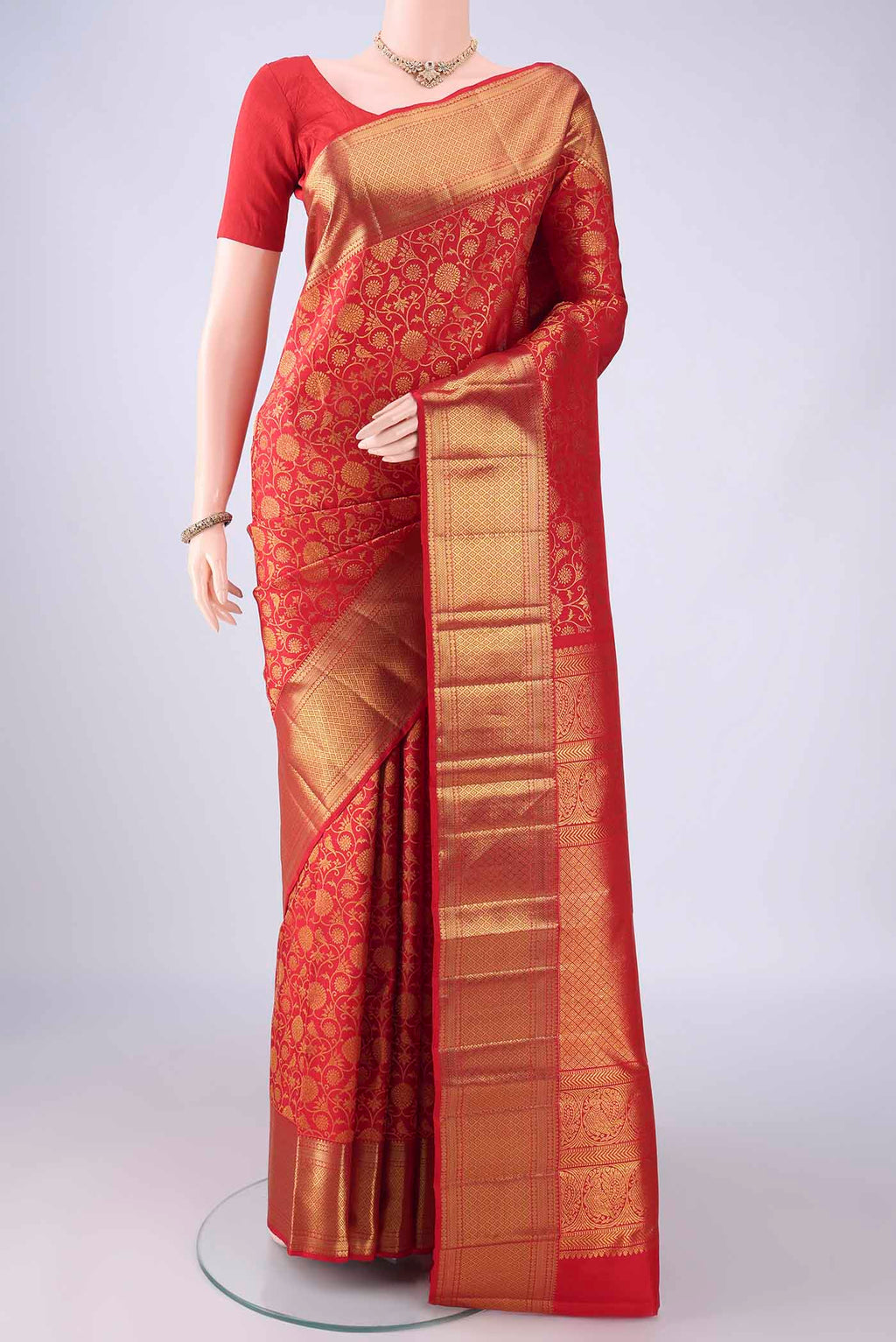 Red Kanchipuram Silk Saree with Zari Brocade on the body and Zari Border.  displayed on a mannequin