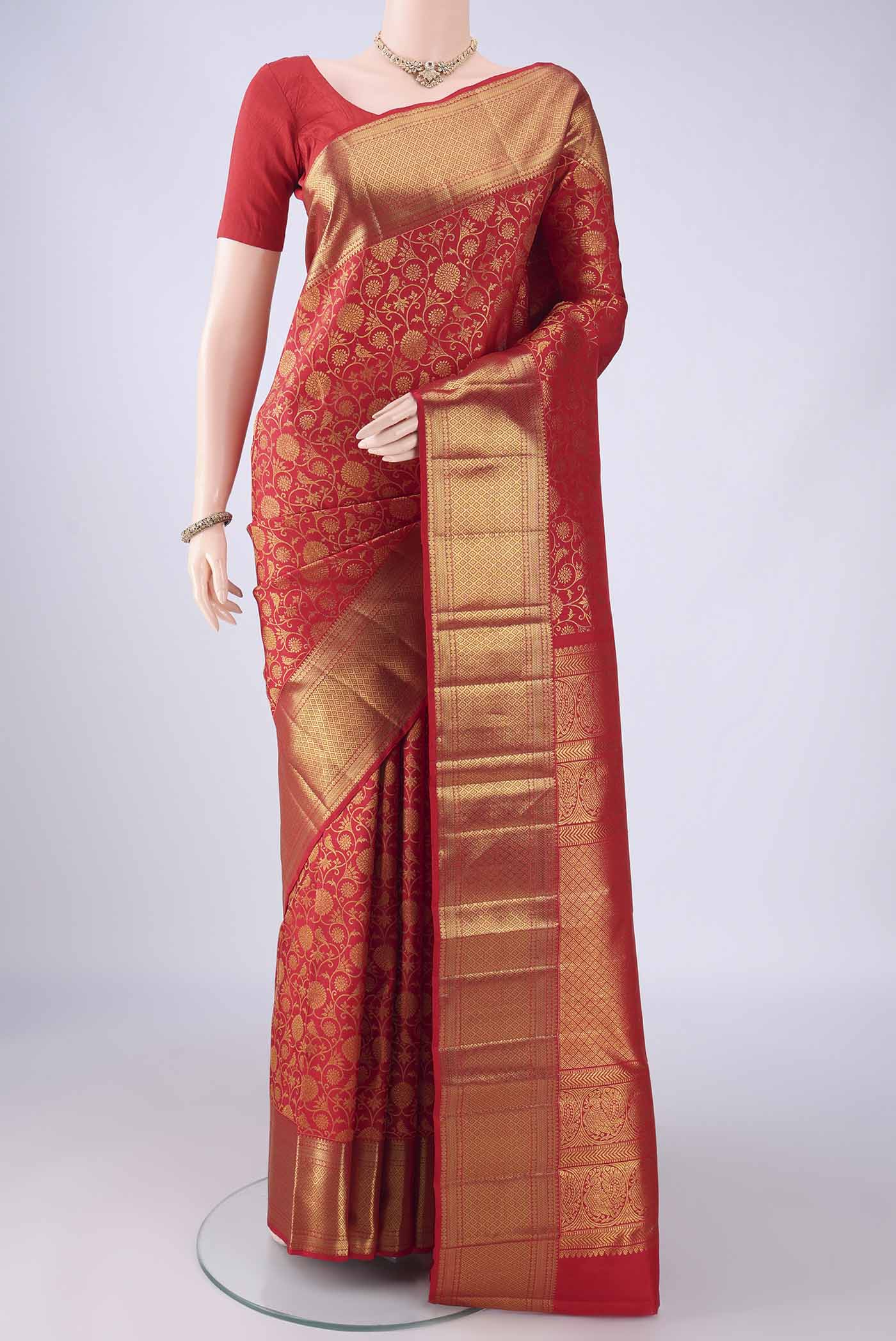 Red Kanchipuram Silk Saree with Zari Brocade on the body and Zari Border.  displayed on a mannequin