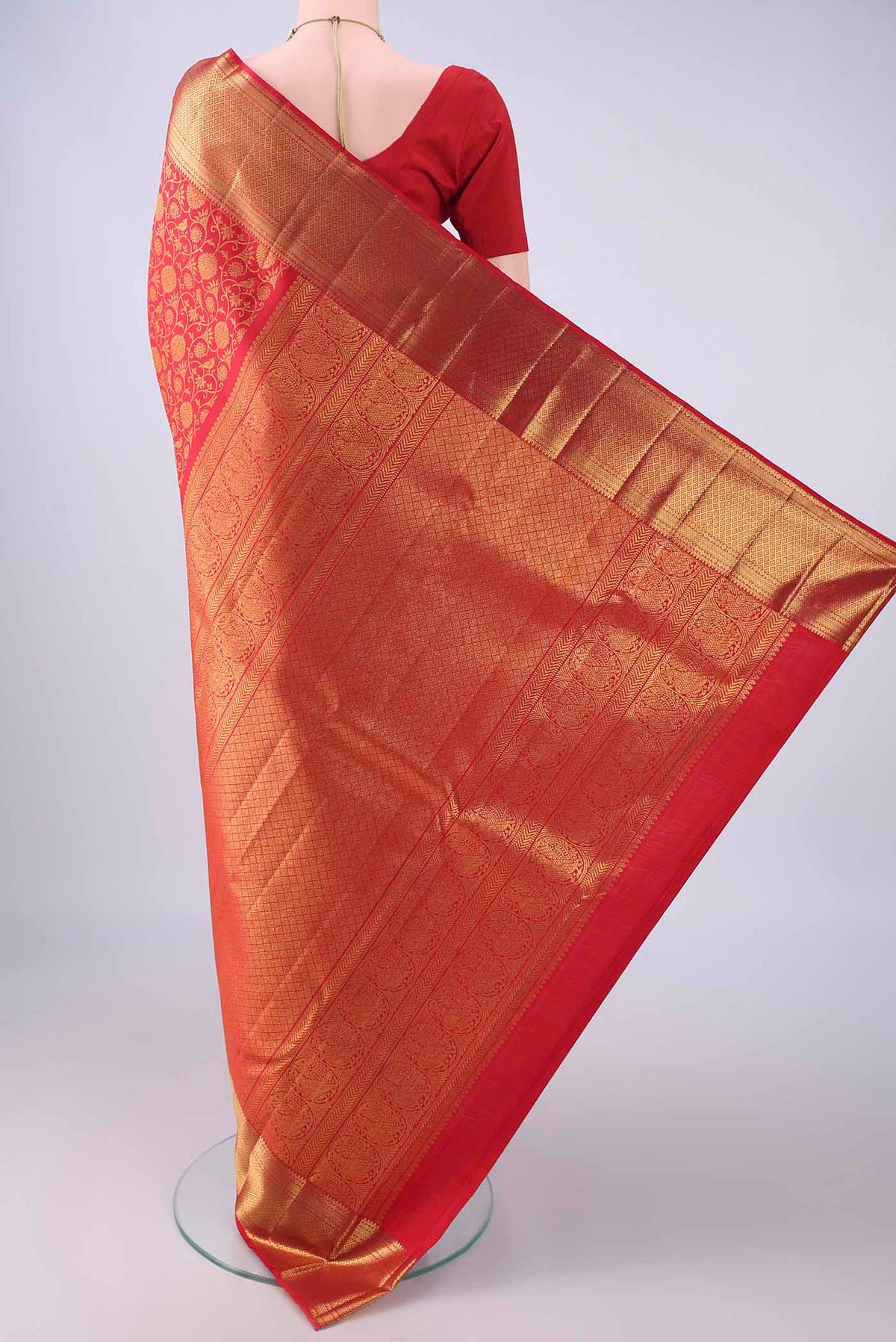 Flat view of Red Kanchipuram Silk Saree with Zari Brocade on the body and Zari Border. 
