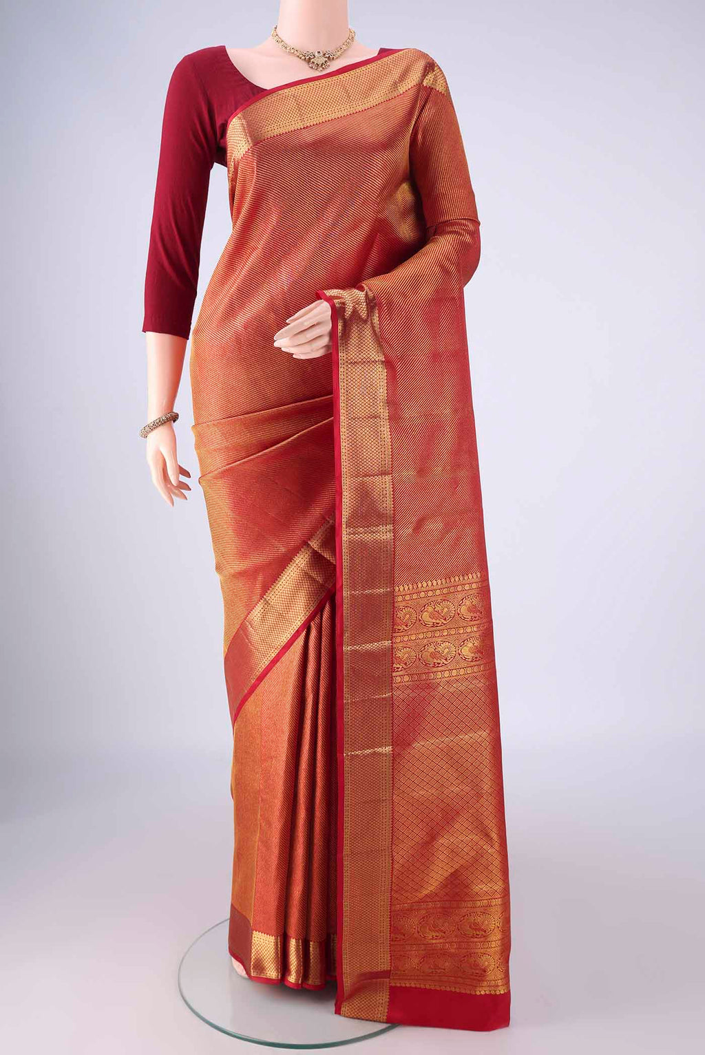 Red Kanchipuram Silk Saree with Zari Brocade on the body and Zari Border.  displayed on a mannequin