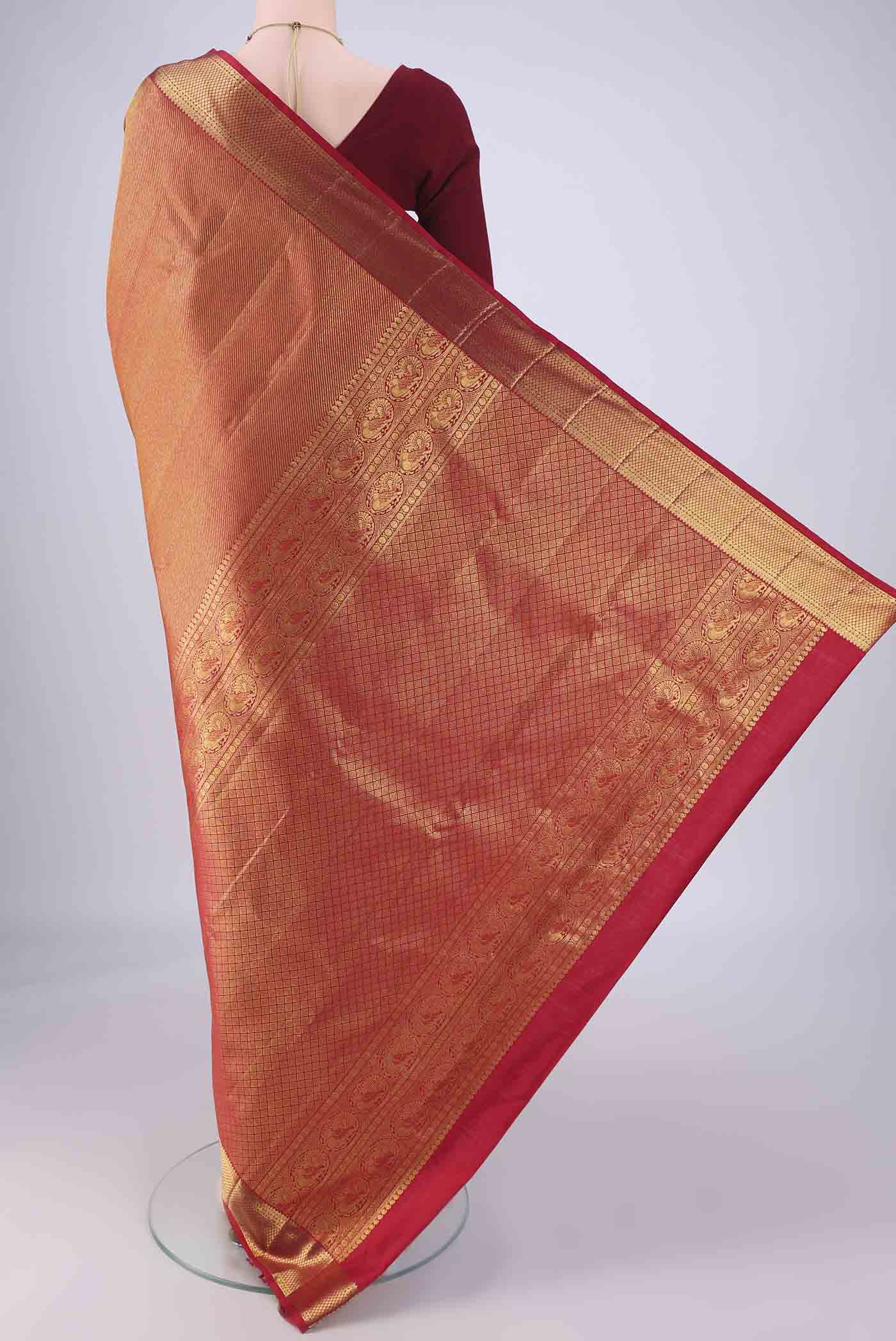 Flat view of Red Kanchipuram Silk Saree with Zari Brocade on the body and Zari Border. 