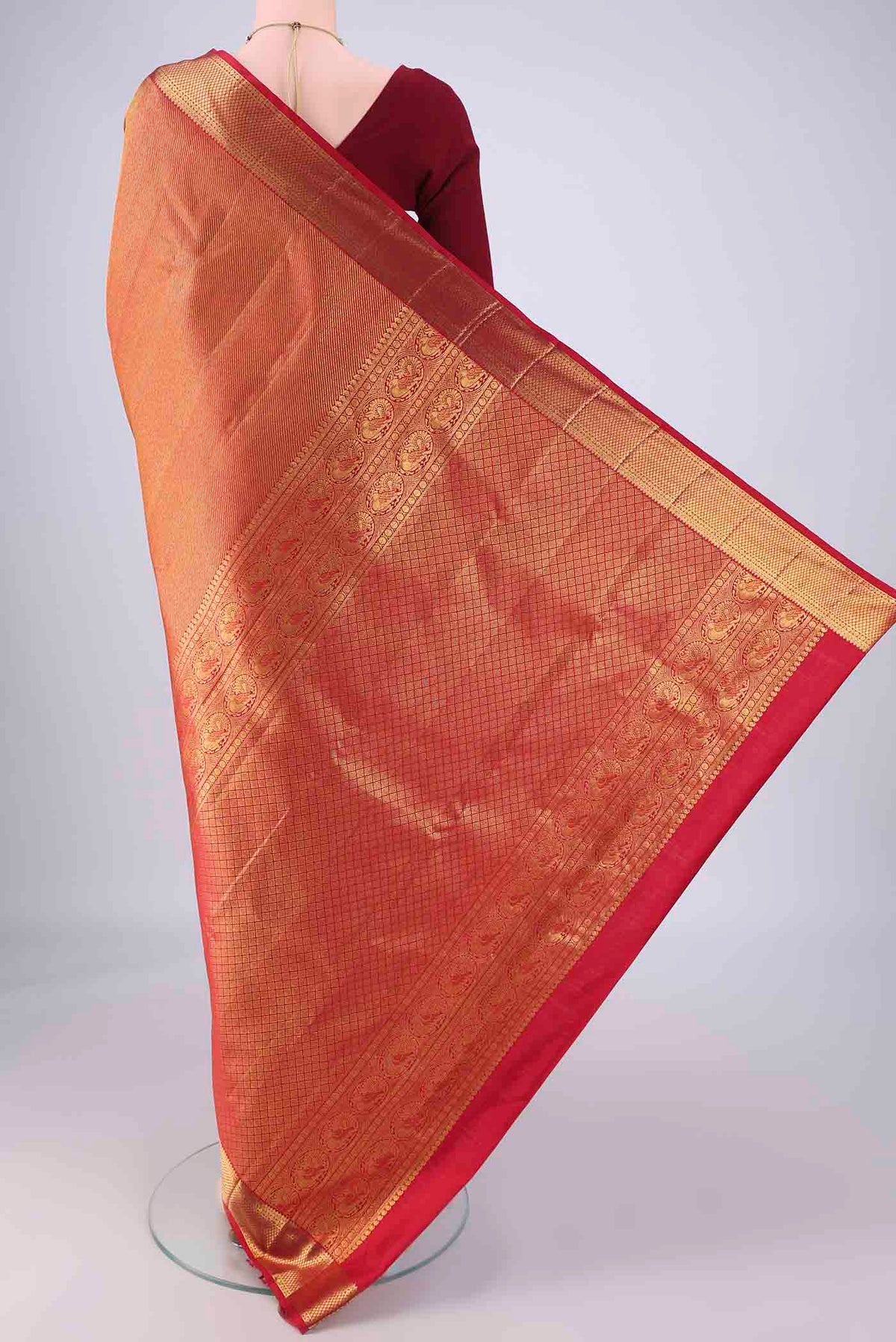Flat view of Red Kanchipuram Silk Saree with Zari Brocade on the body and Zari Border. 
