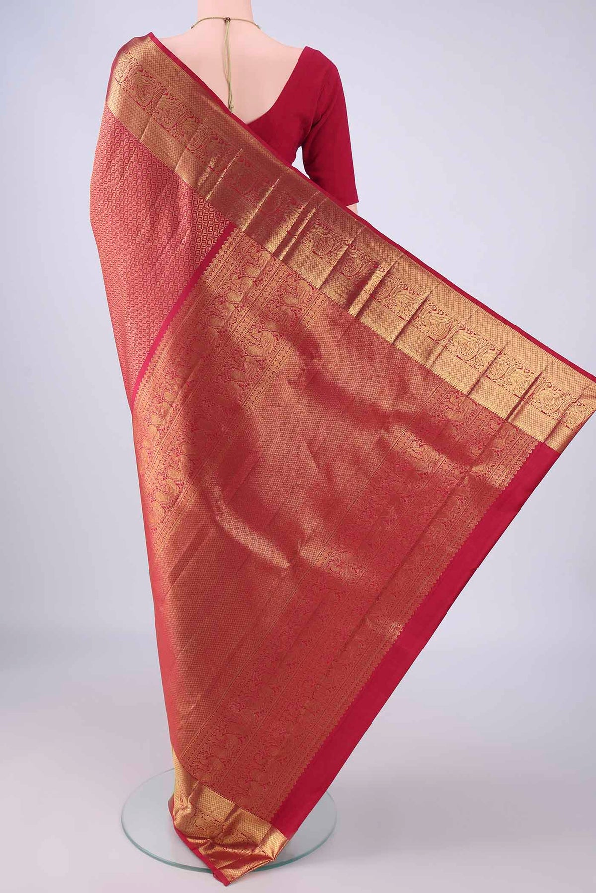 Flat view of Maroon Kanchipuram Silk Saree with Zari Brocade on the body and Zari Border. 