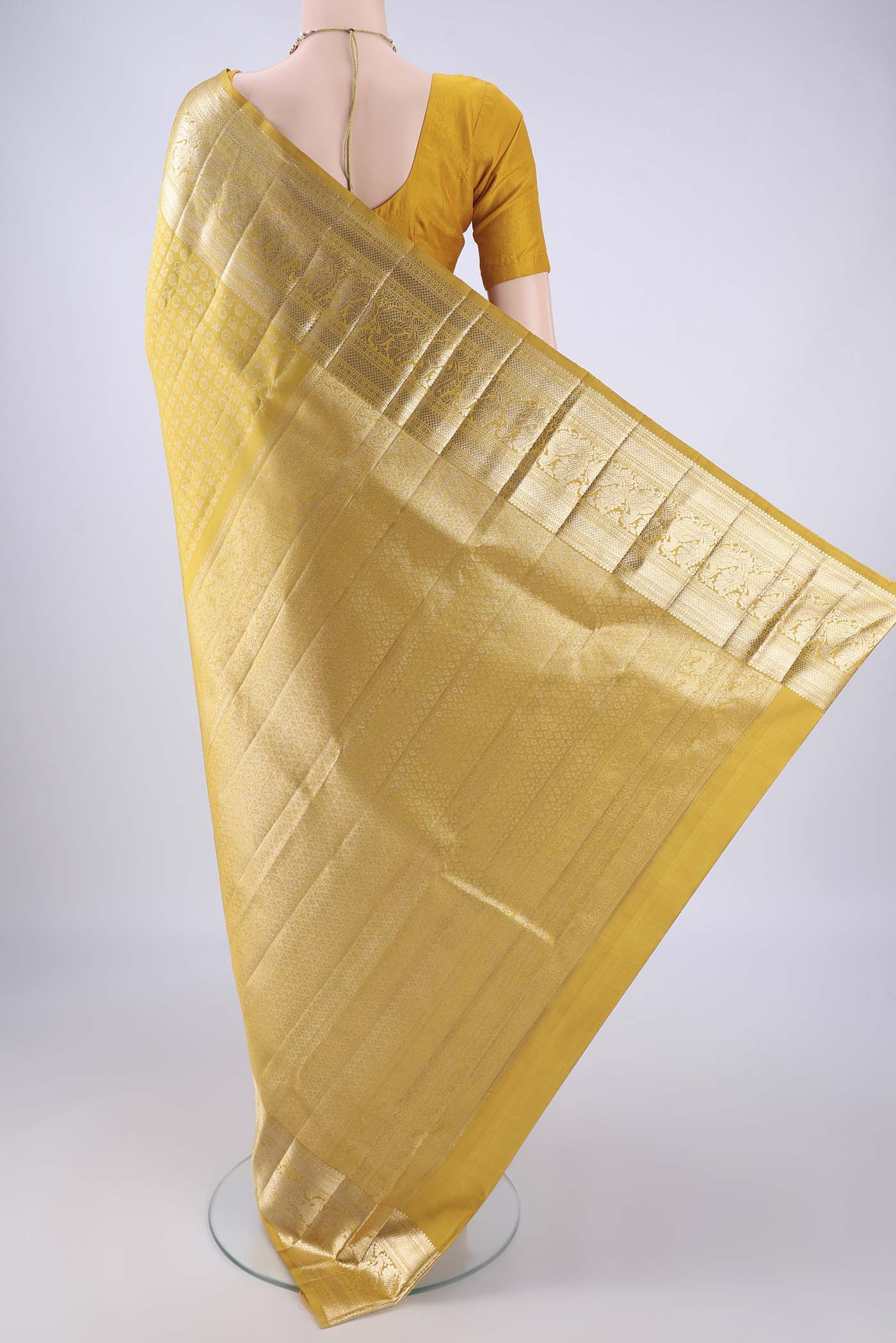 Flat view of Mustard Kanchipuram Silk Saree with Zari Brocade on the body and Zari Border. 