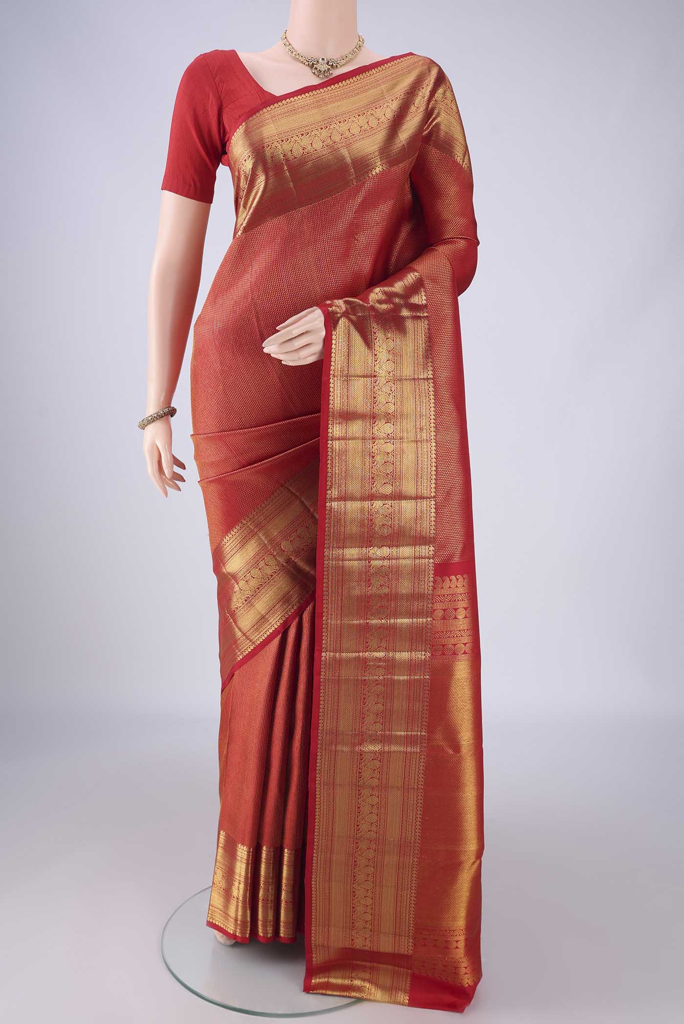 Red Kanchipuram Silk Saree with Zari Brocade on the body and Zari Border.  displayed on a mannequin