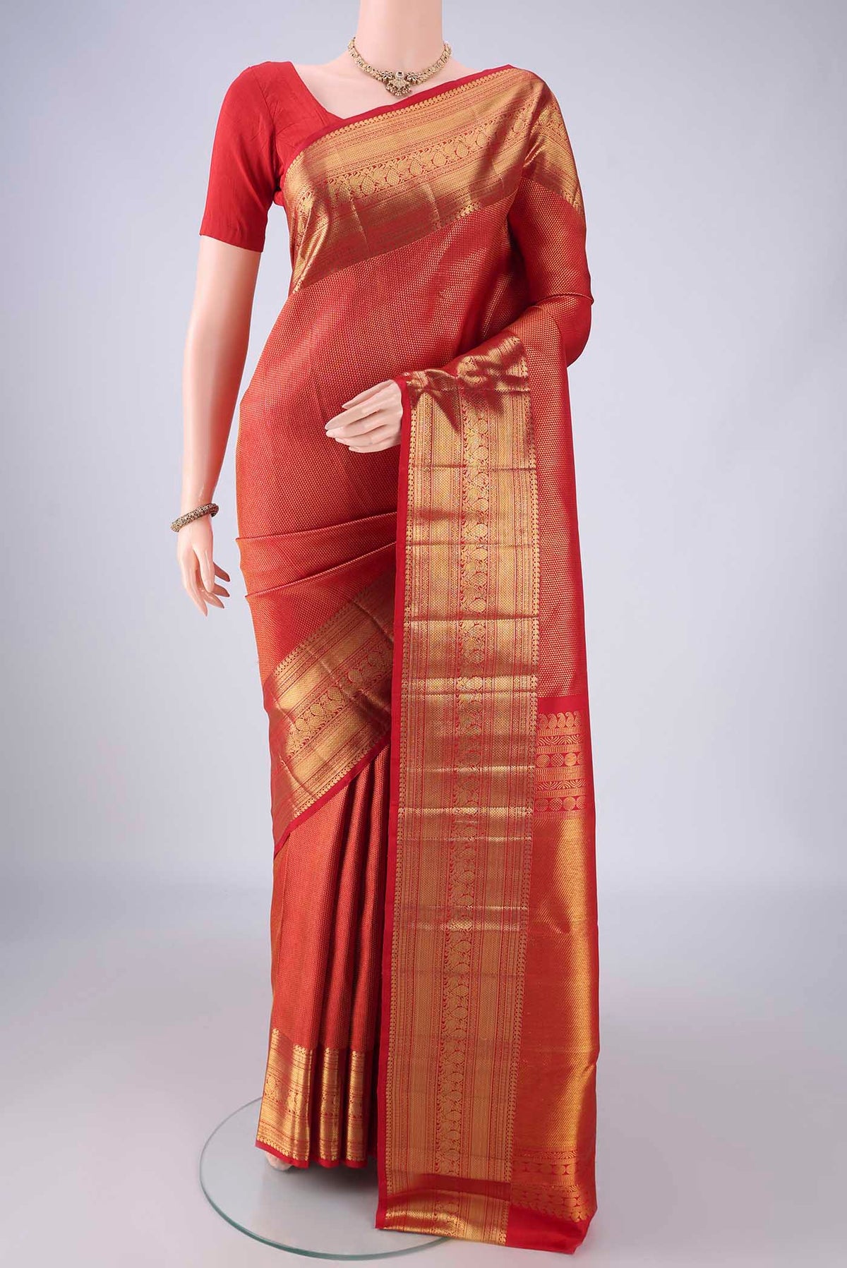 Red Kanchipuram Silk Saree with Zari Brocade on the body and Zari Border.  displayed on a mannequin