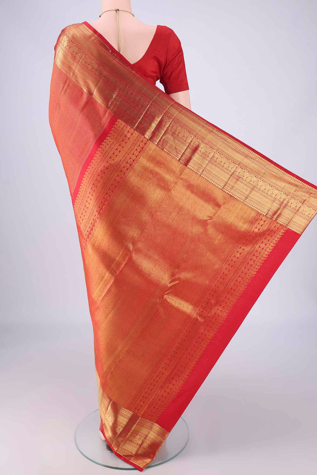 Flat view of Red Kanchipuram Silk Saree with Zari Brocade on the body and Zari Border. 