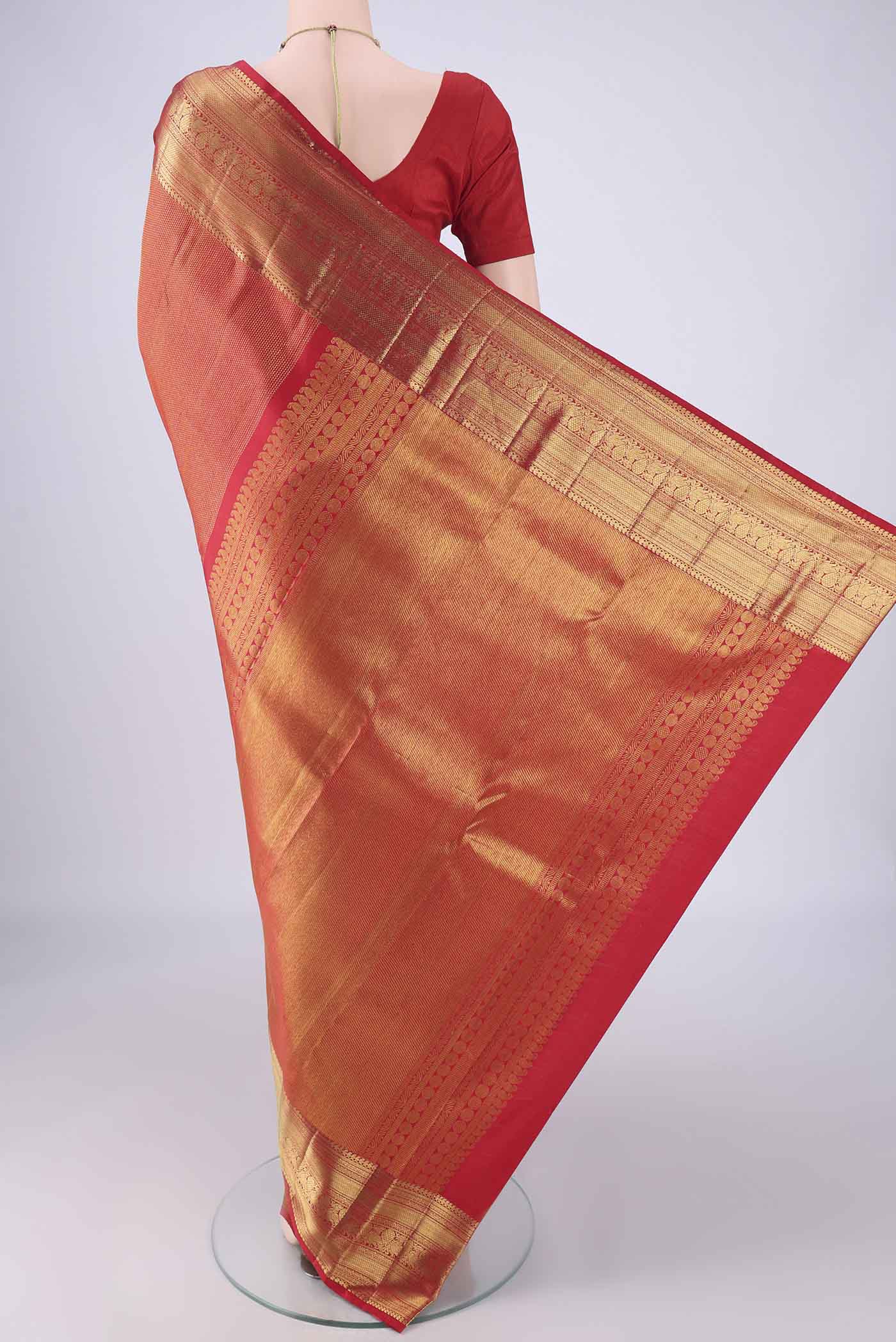 Flat view of Red Kanchipuram Silk Saree with Zari Brocade on the body and Zari Border. 