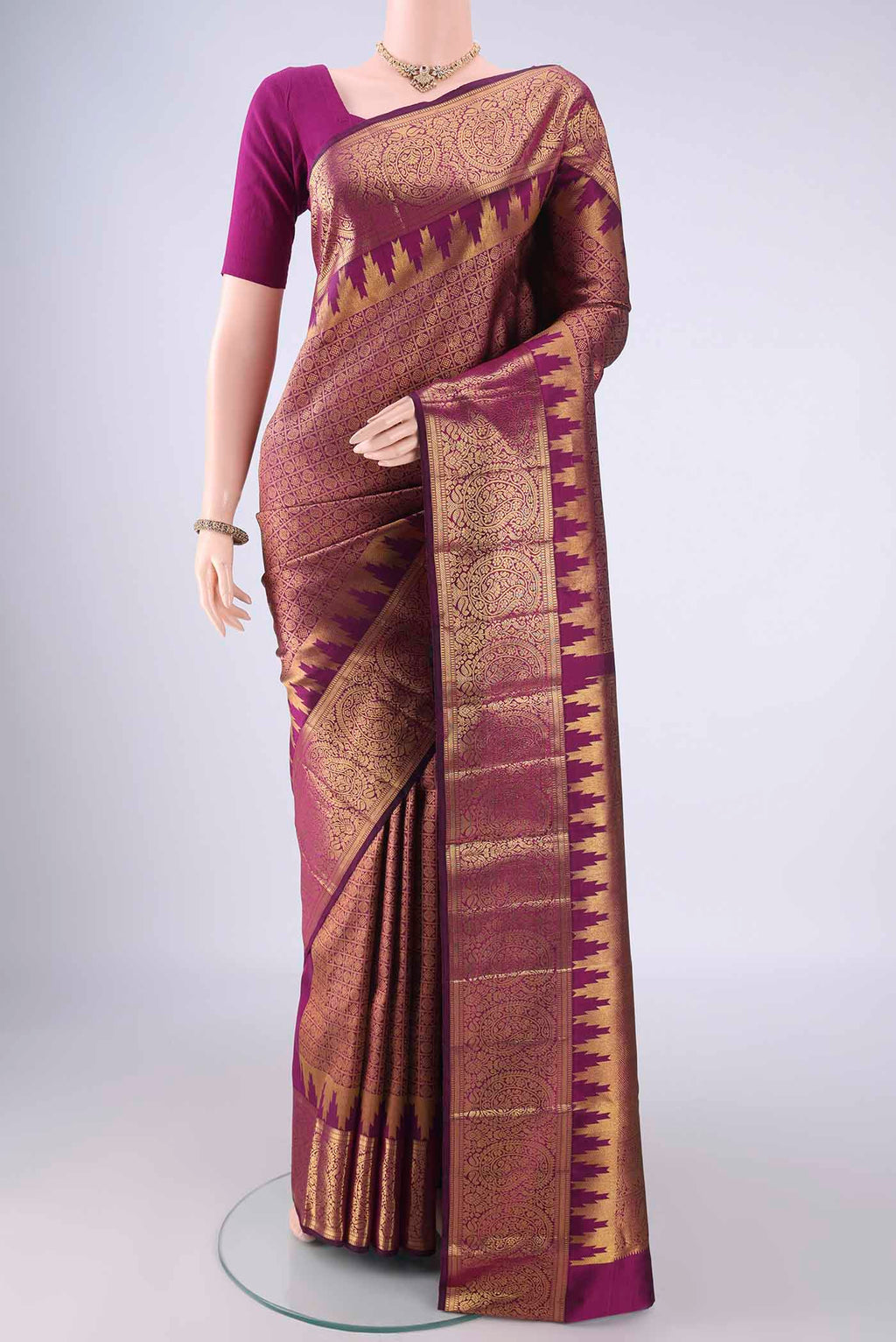 Purple Kanchipuram Silk Saree with Zari Brocade on the body and Zari Border.  displayed on a mannequin