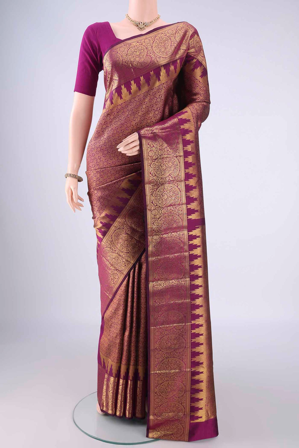 Purple Kanchipuram Silk Saree with Zari Brocade on the body and Zari Border.  displayed on a mannequin