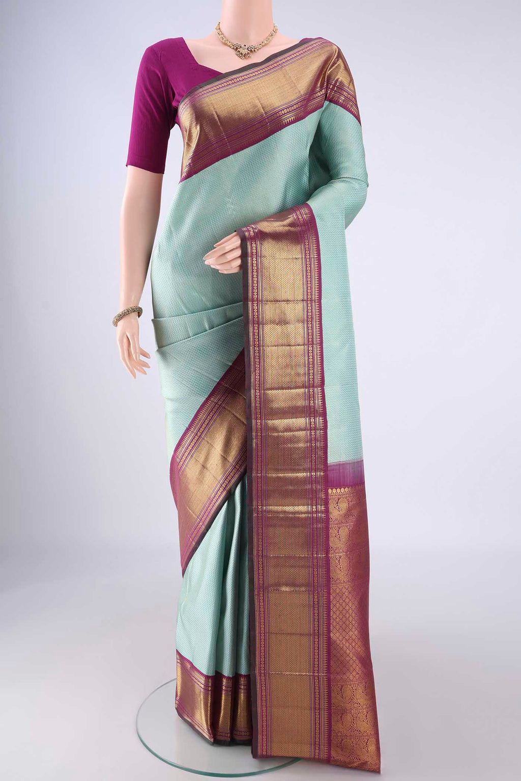 Light Blue Kanchipuram Silk Saree with Zari Brocade on the body and Zari Border.  displayed on a mannequin