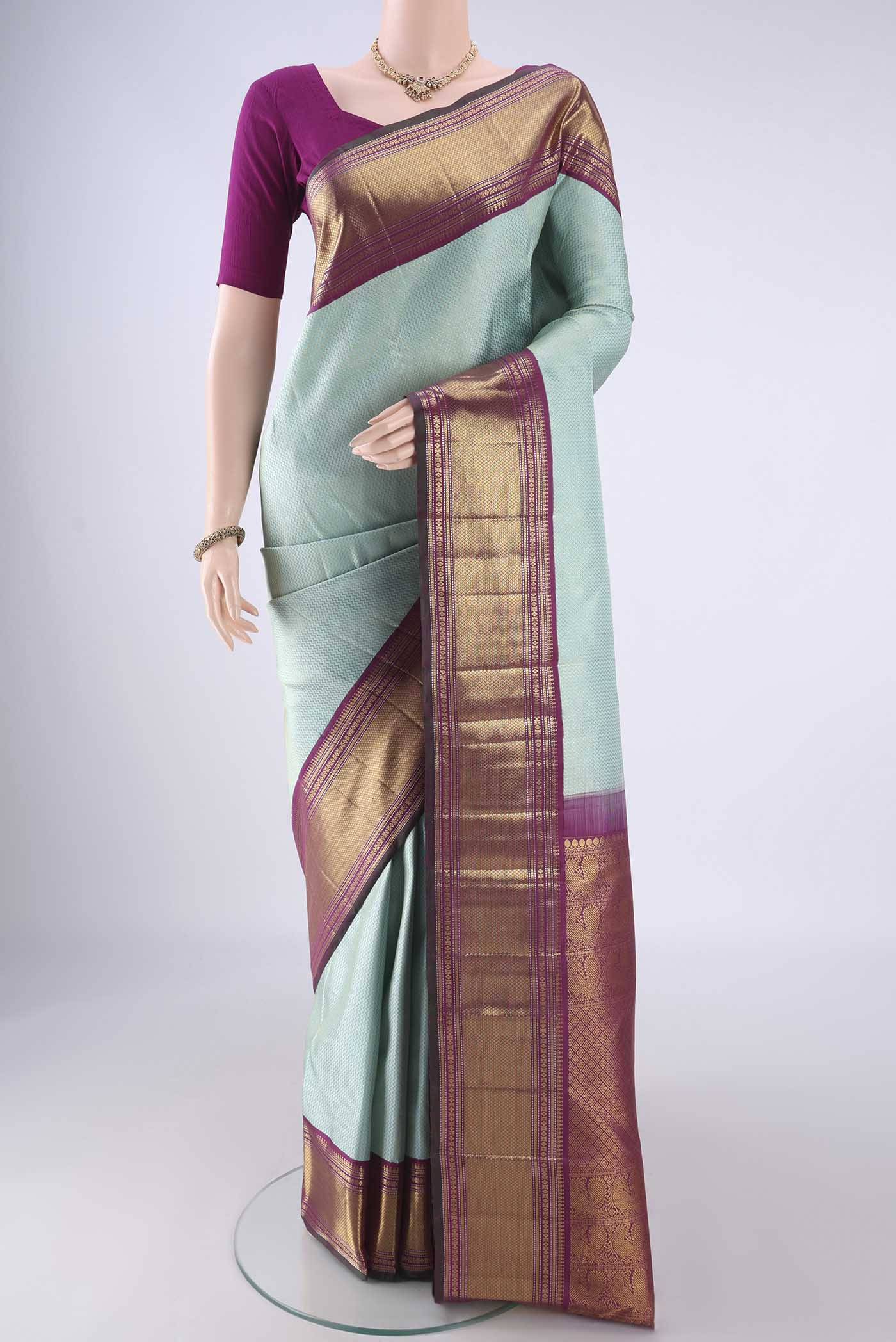Light Blue Kanchipuram Silk Saree with Zari Brocade on the body and Zari Border.  displayed on a mannequin